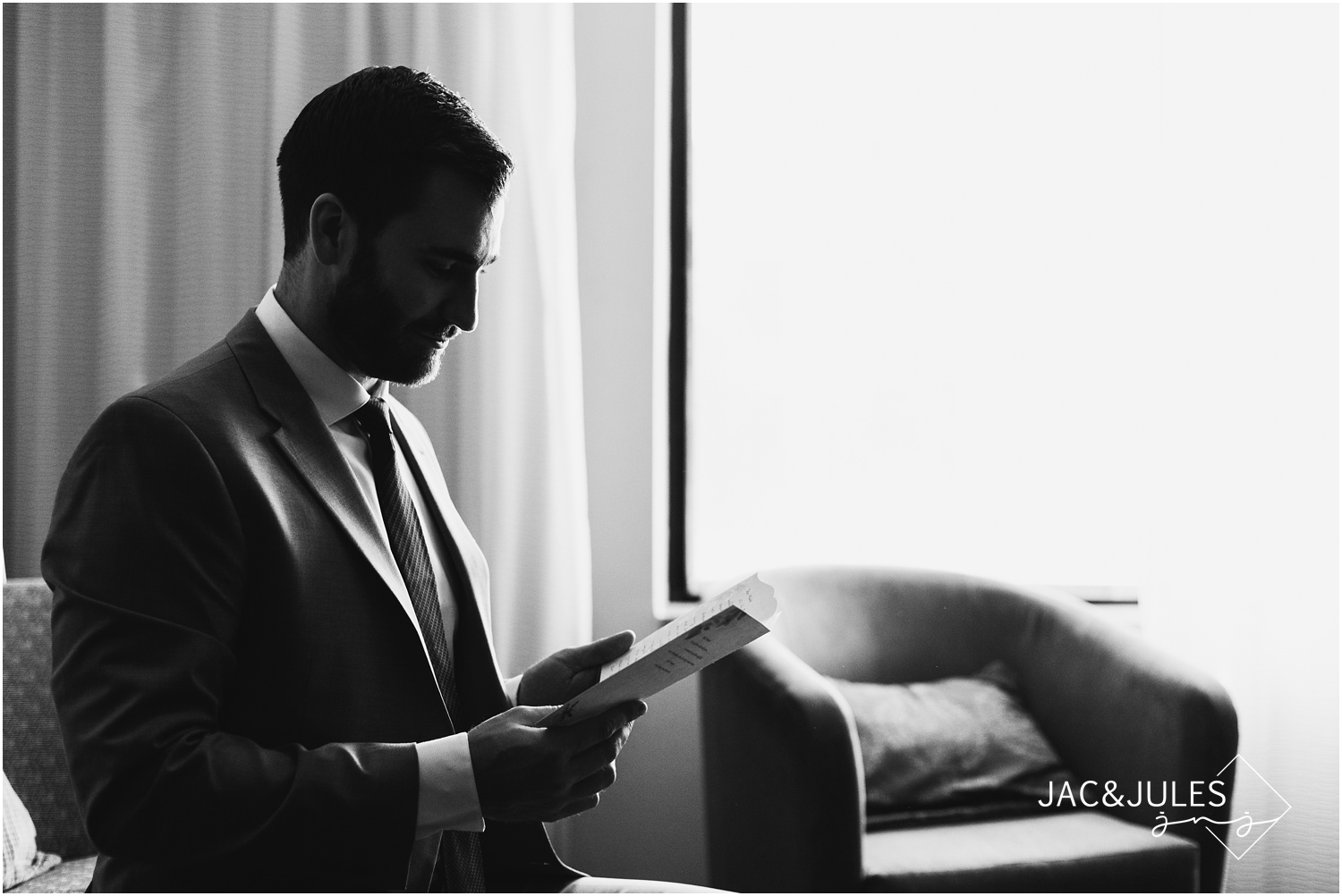 Groom reading card at Courtyard Marriott in Wall, NJ