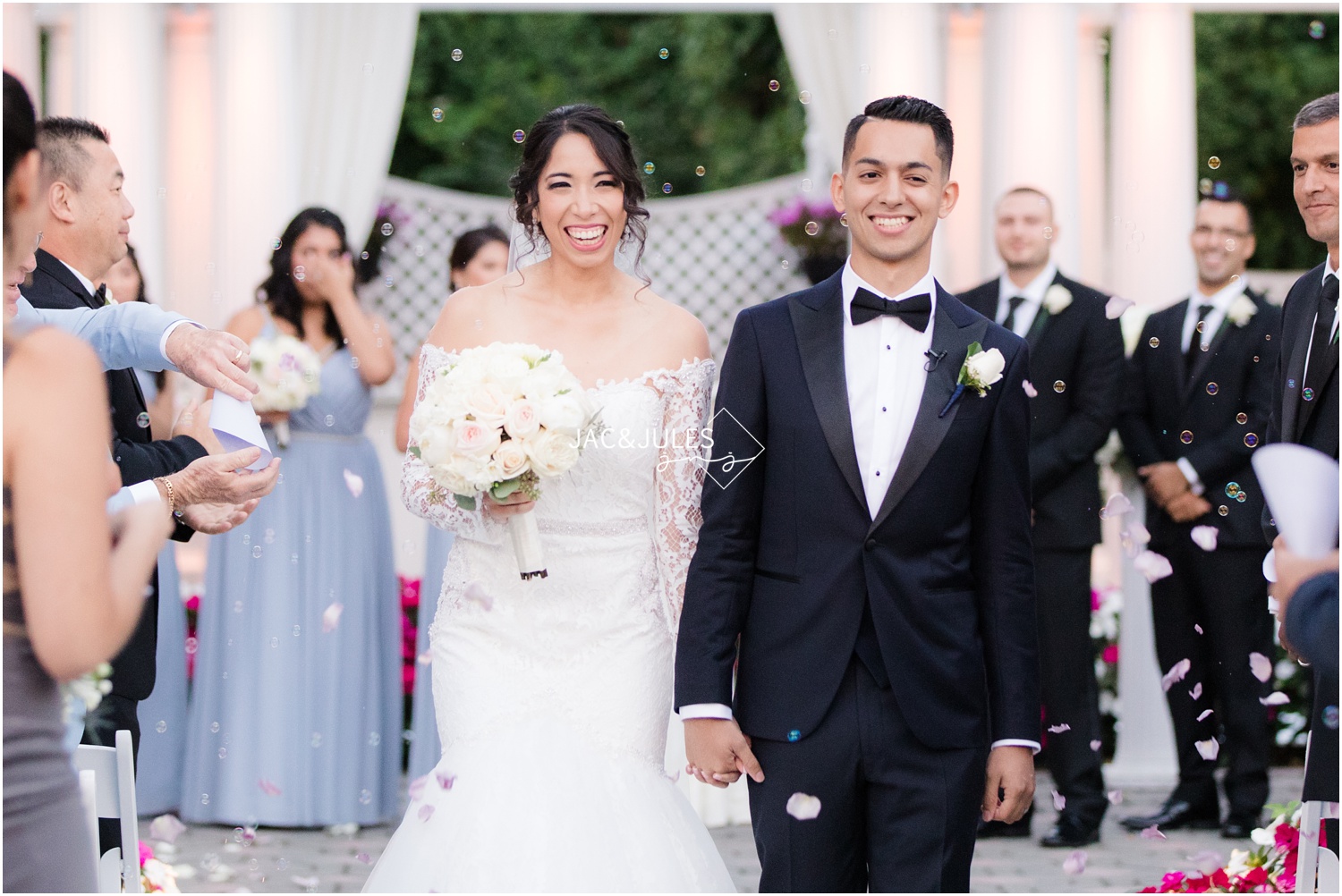 Bride and groom exit wedding ceremony at The Shadowbrook in Shrewsbury, NJ.