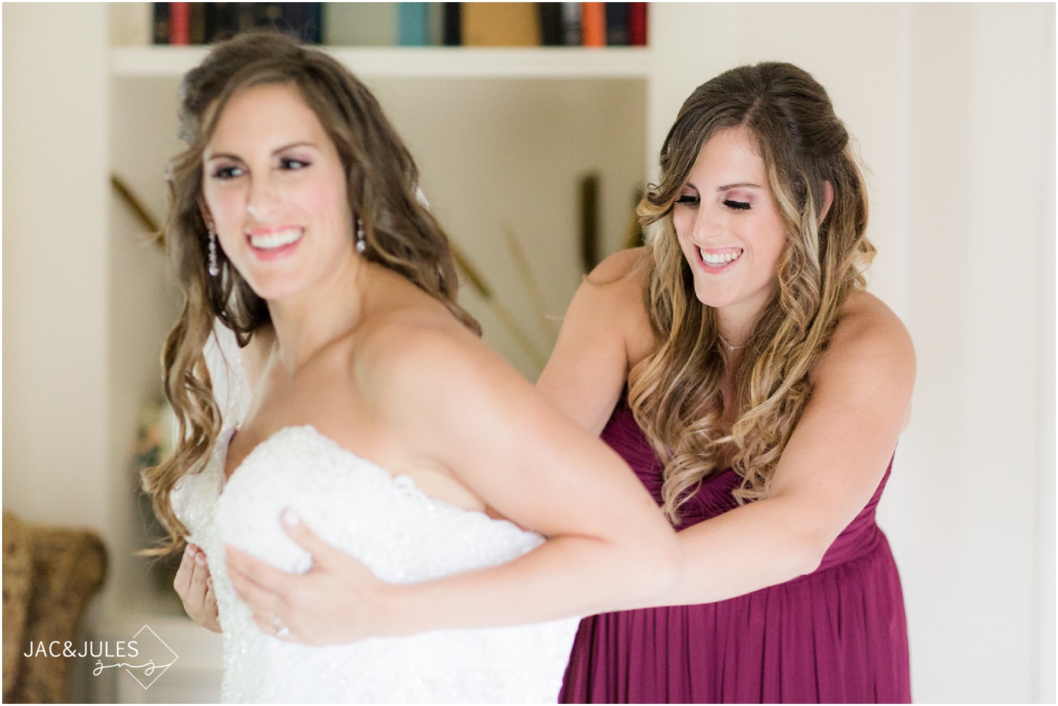 Photo of sister helping the bride get dressed at The Olde Mill Inn in Basking Ridge, NJ.