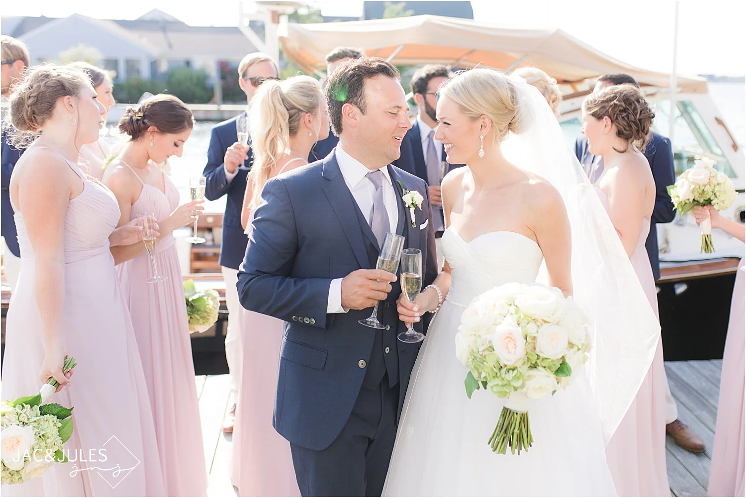 Natural light wedding photo of bride and groom and bridal party at bay head yacht club with a boat and cocktails