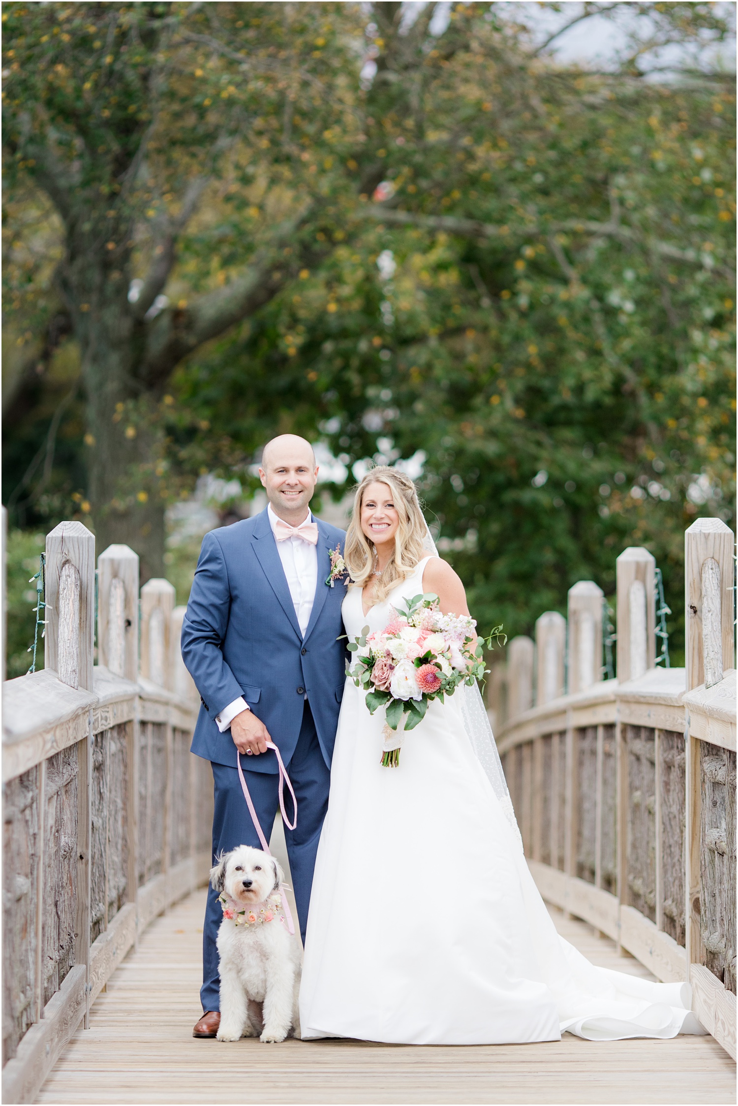 Bride and groom with their dog on the bridge at Devine Park in Spring Lake, NJ.