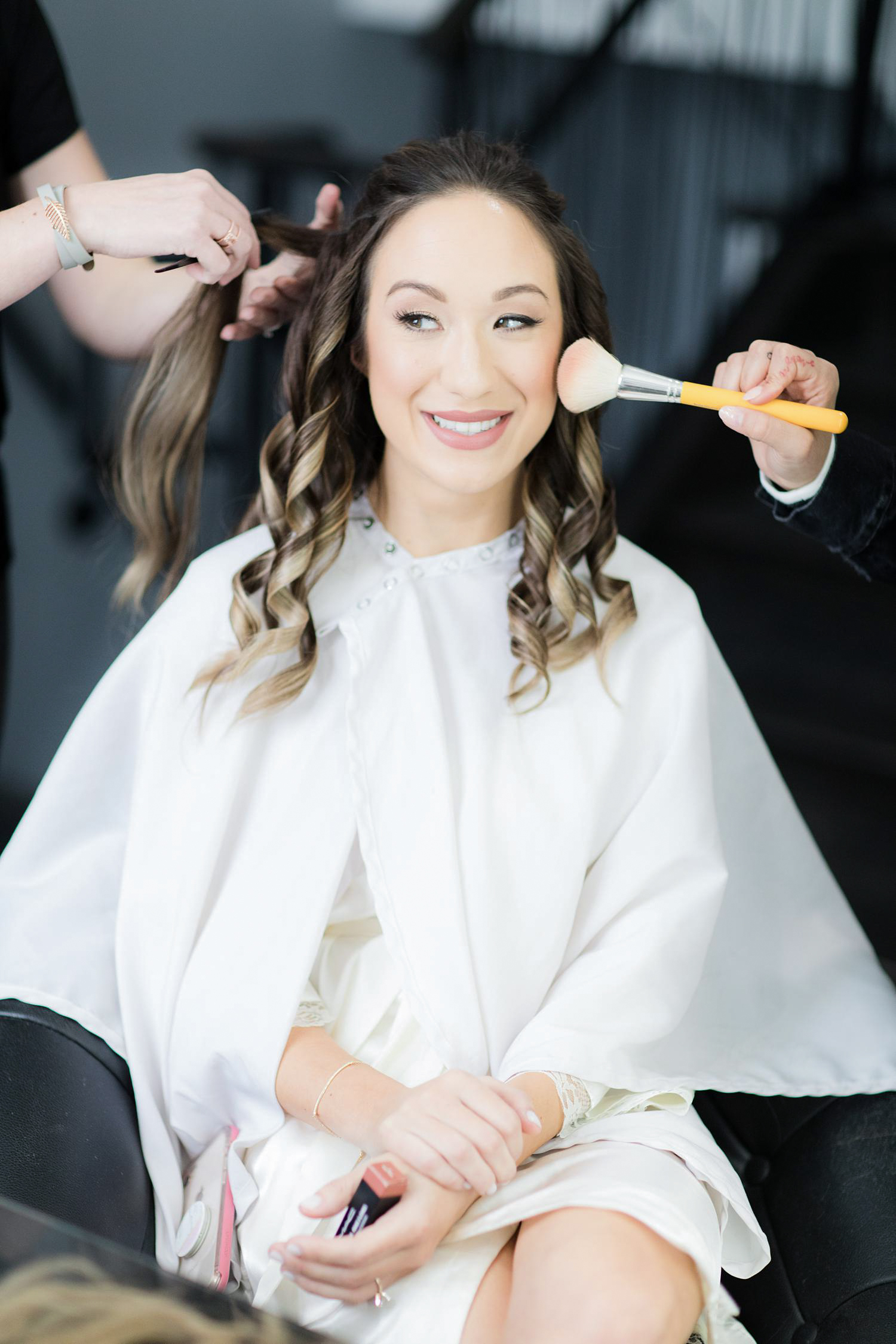 Bride getting her makeup done by Make Me Up Eva at The Ryland Inn