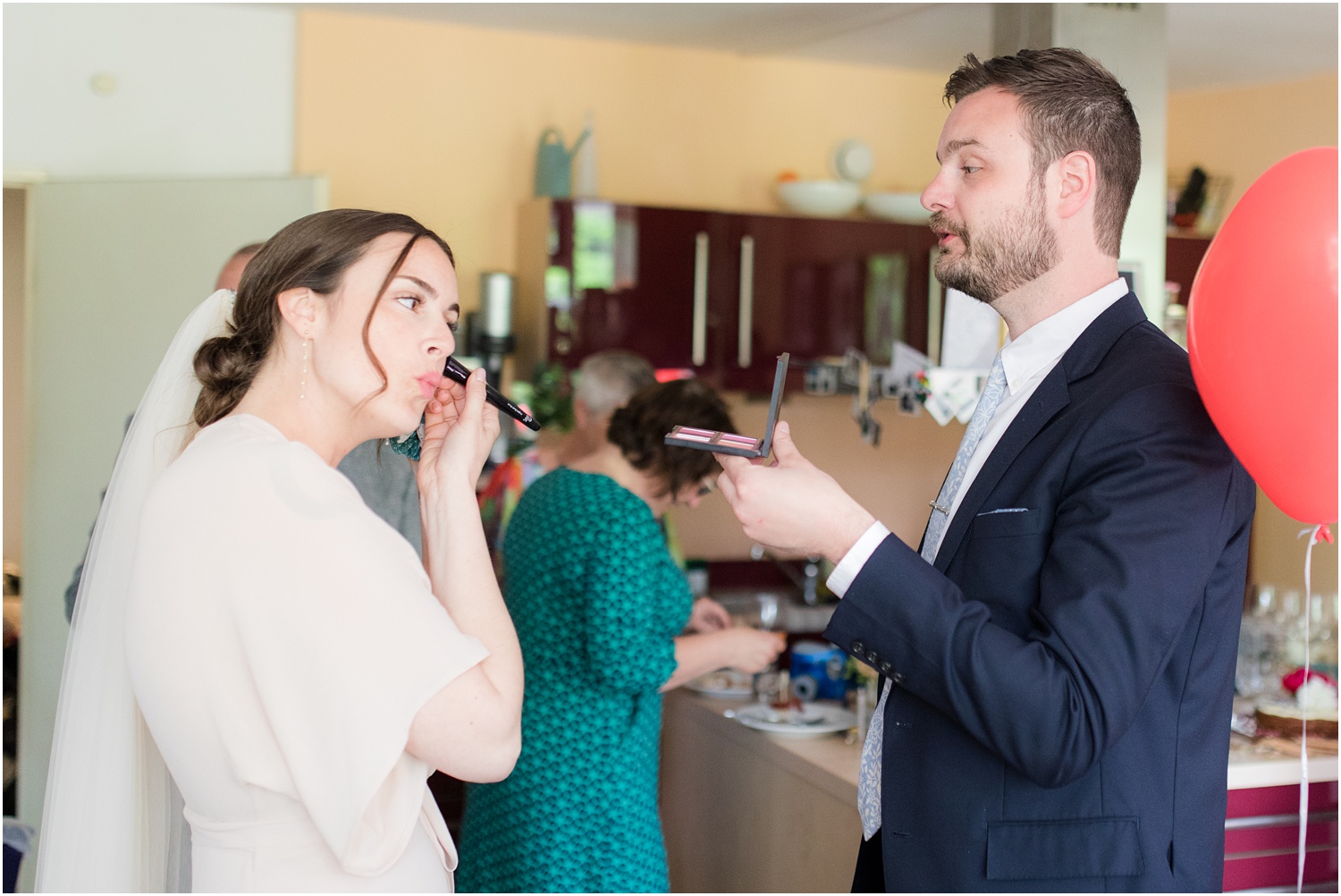 bride touching up her makeup