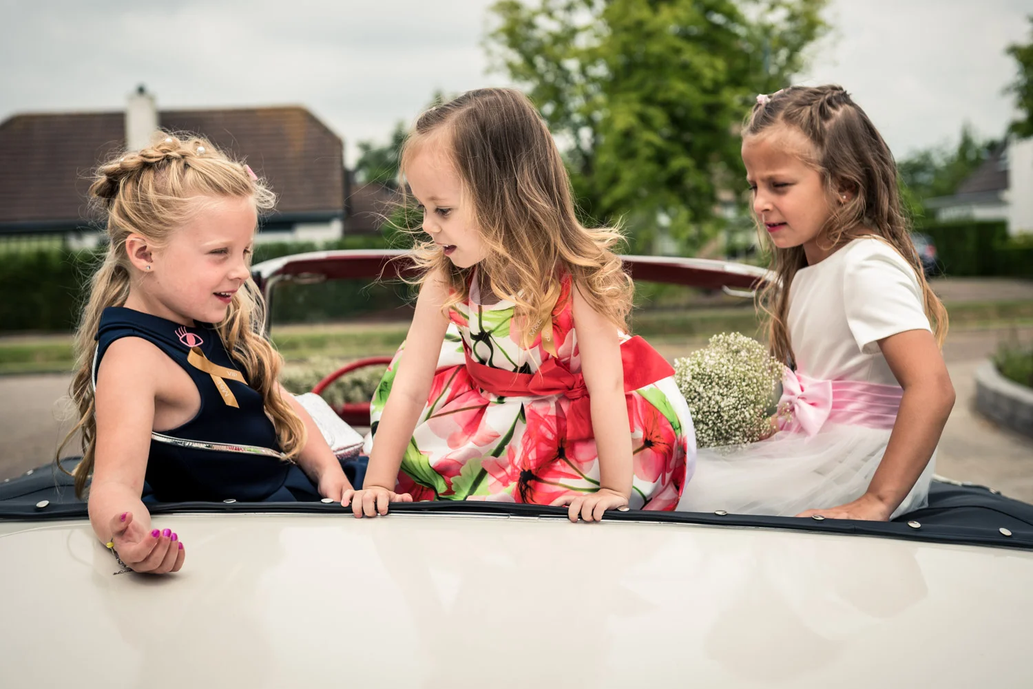 bruidskindjes spelen in de trouwauto in West Brabant door Caroline bruidsfotograaf bij Cfoto