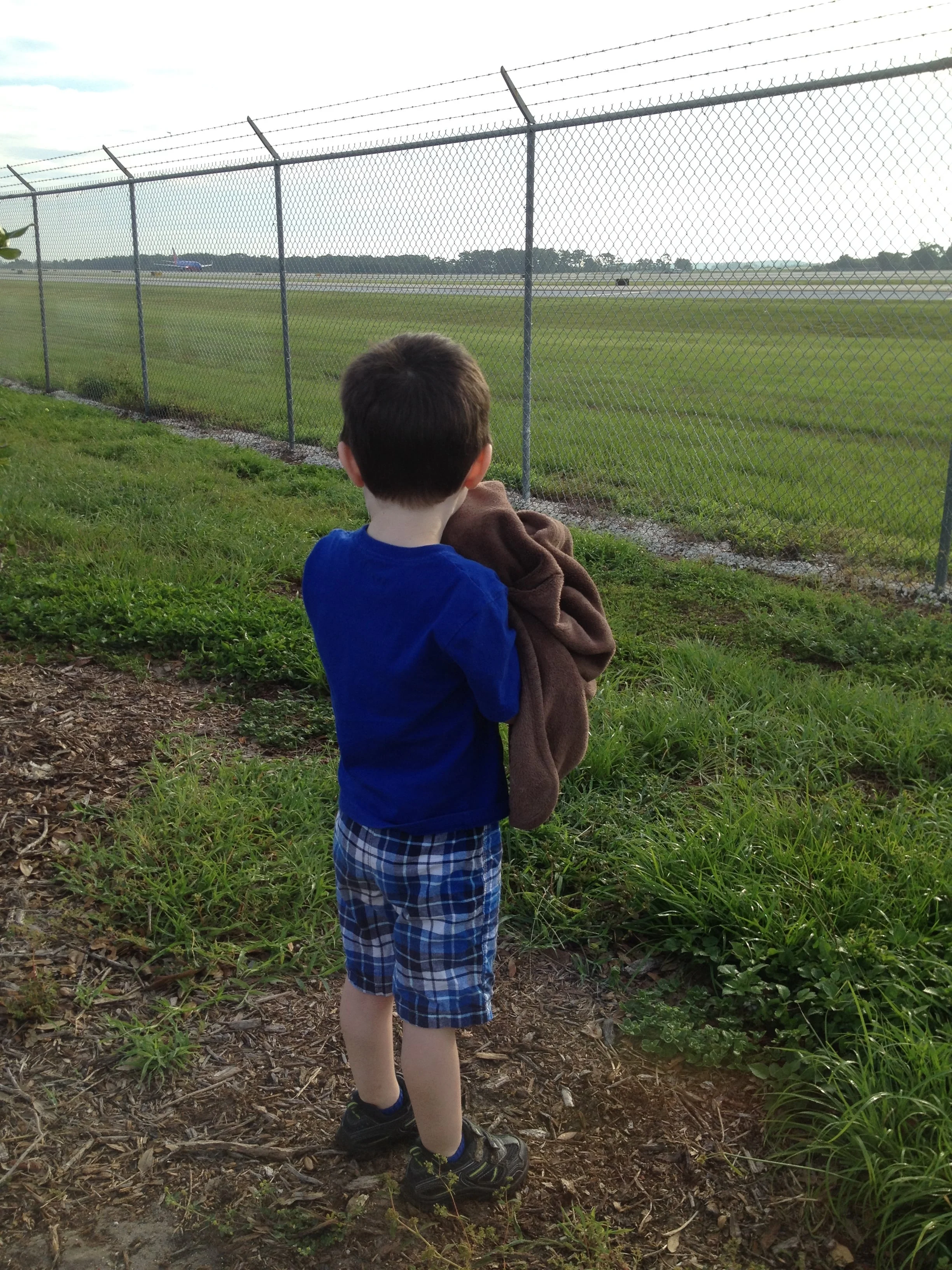 Not Mommy's airplane in the background; Jacob looking on