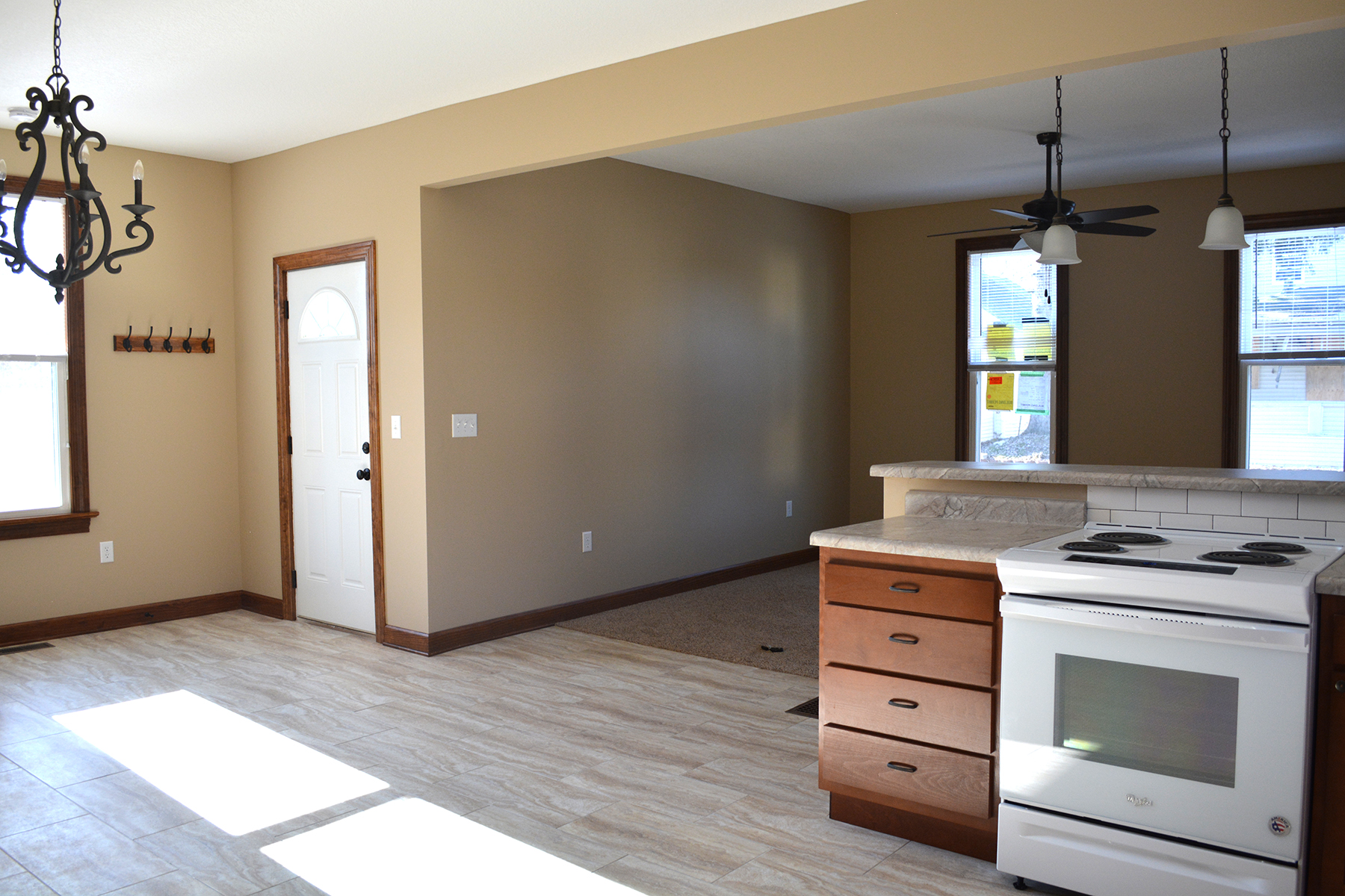 AFTER: The kitchen is now in the center of the house, open to the entry, dining, and living rooms.