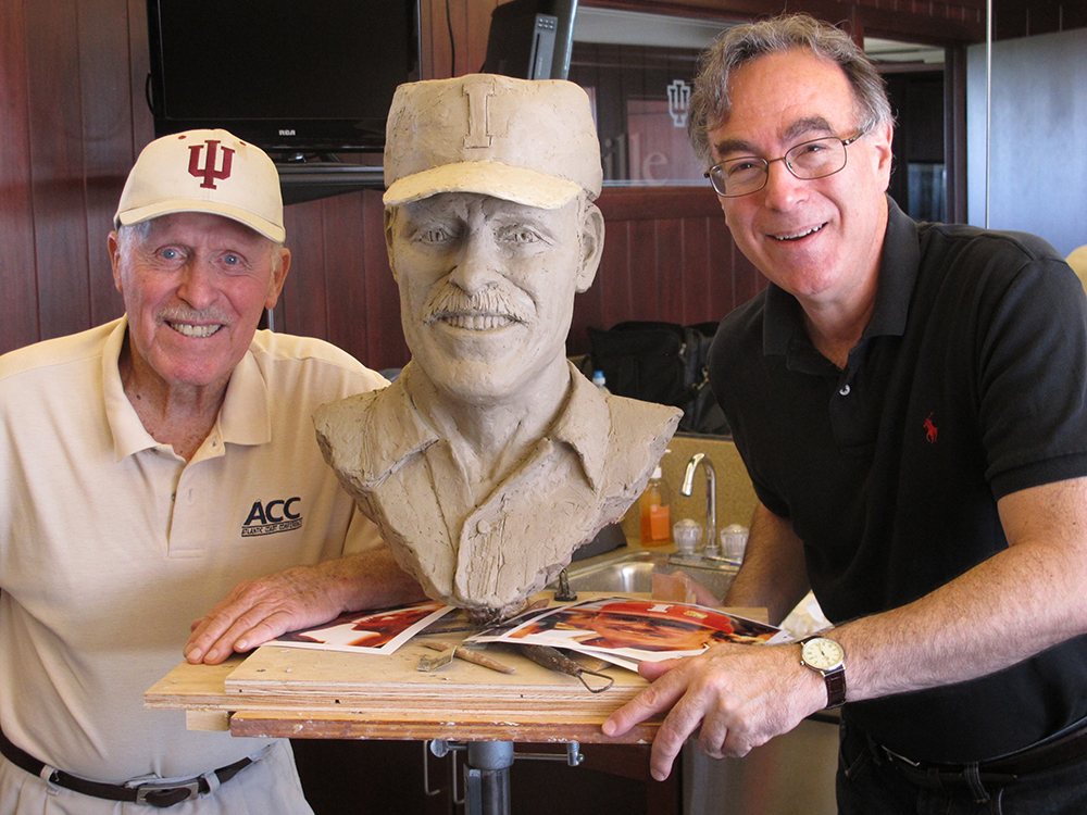   Hobie Billingsley with sculptor Marc Mellon and in process portrait bust of Hobie as he looked during his coaching days.  