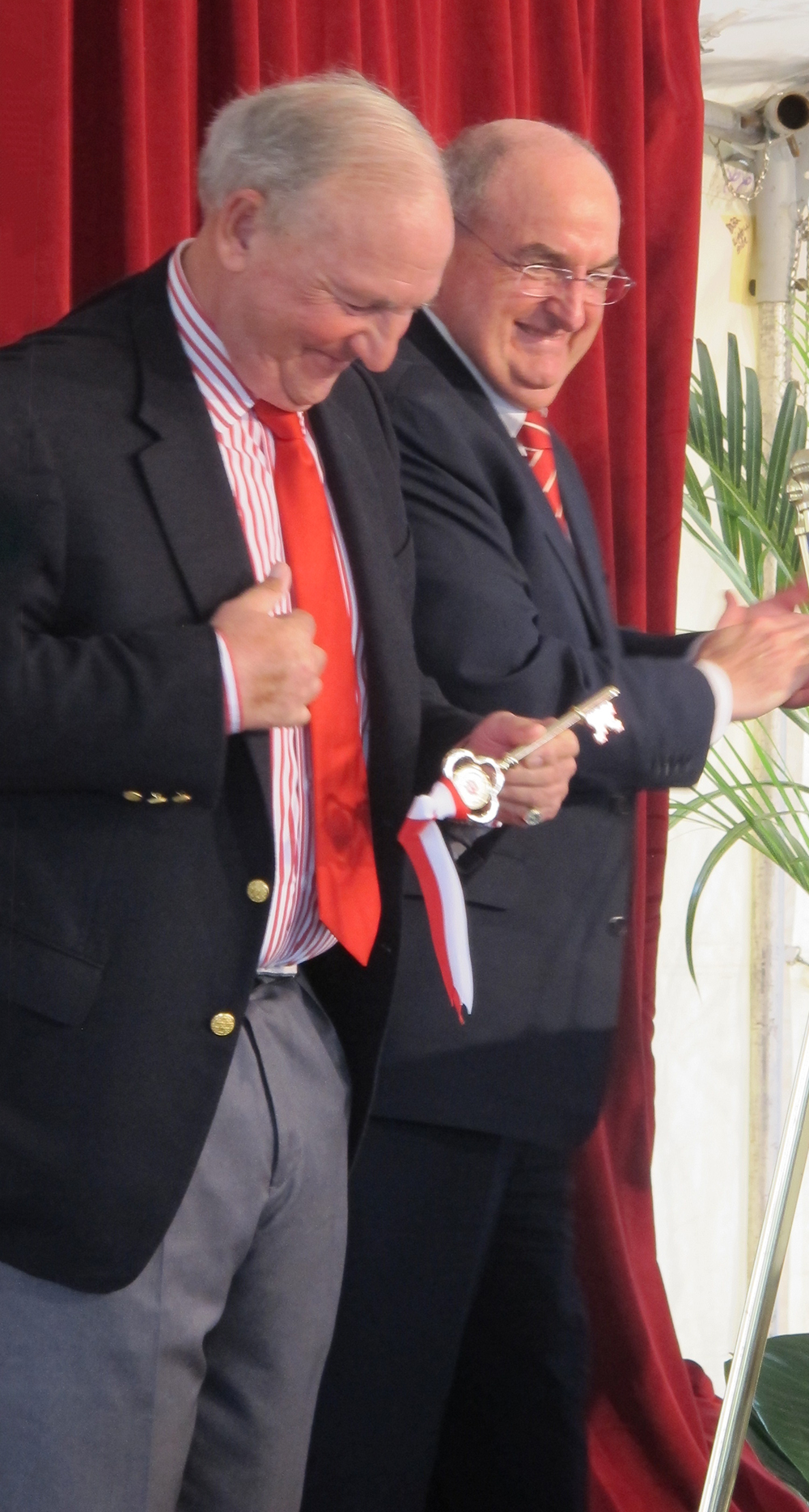   President Michael McRobbie applauds as lead donor Bart Kaufman receives "key" to the new Bart Kaufman Field.  