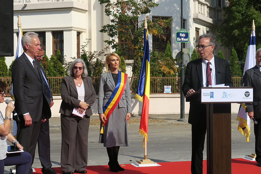  Marc delivering remarks in tribute to Elie Wiesel at the dedication. Pictured left to right: Mayor of Bucharest Gabriela Firea, Israeli Ambassador to Romania Tamar Samash, and US Ambassador to Romania Hans Klemm. 