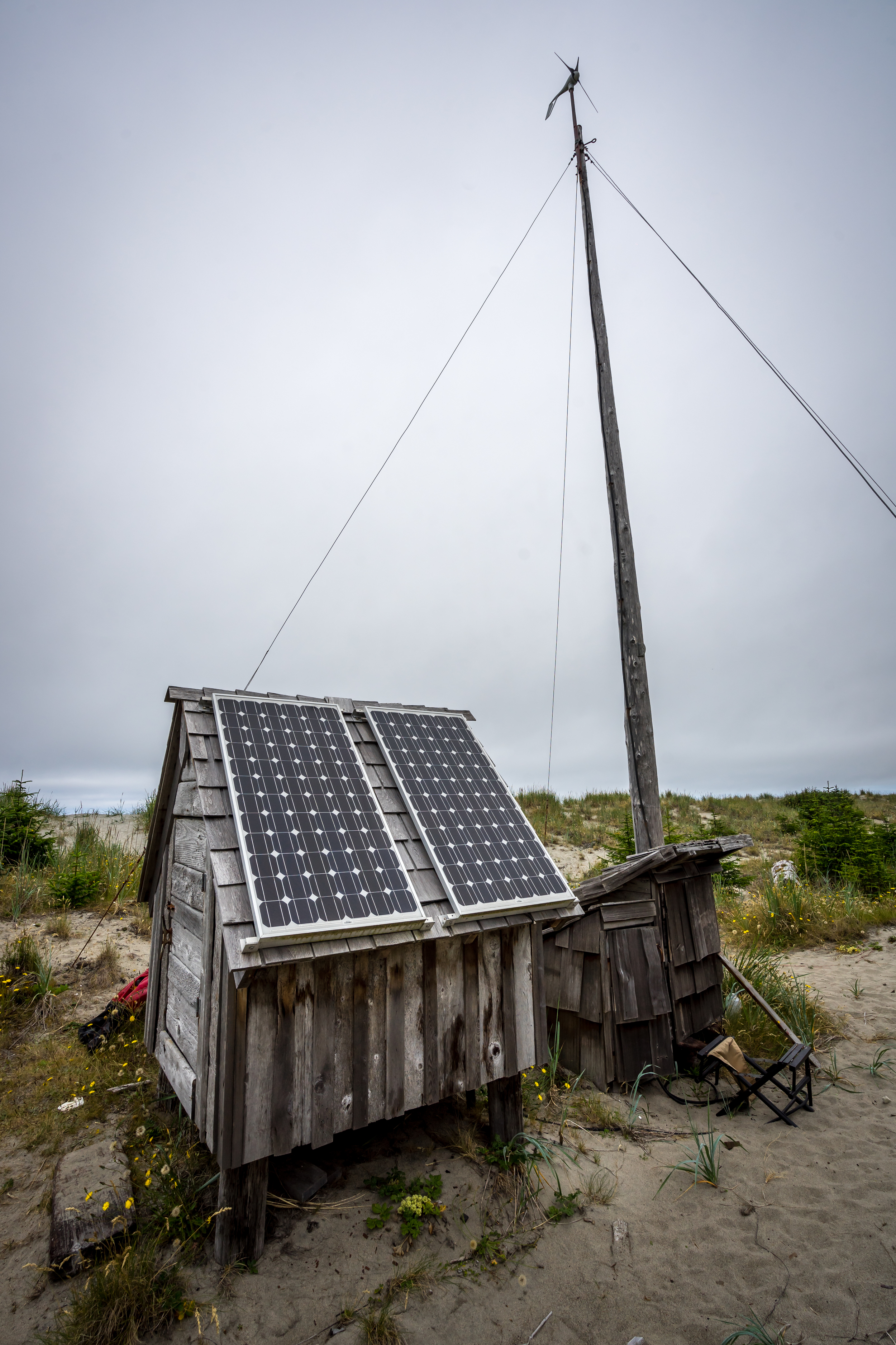 The small power station on the beach. A total of one wind turbine and two solar arrays power 4 homes for 8 months of the year. During the winter months winds are two strong for the wind turbine and not enough light reaches the panels, th
