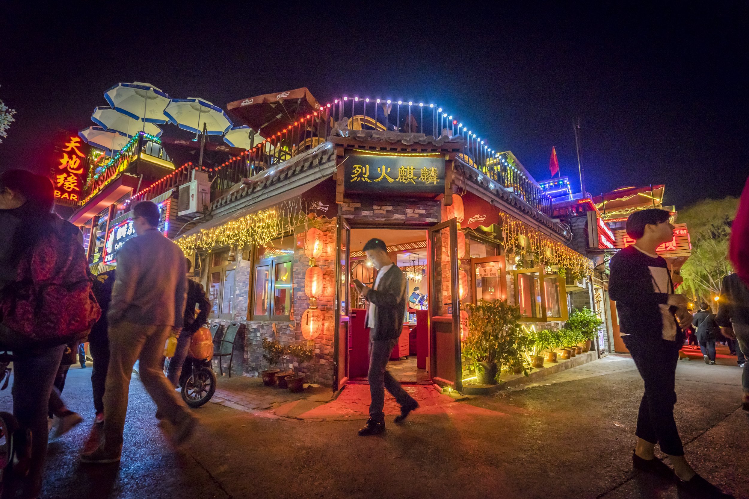  A few days into our time exploring Beijing we ended up in the Houhai nightlife district. There we found endless bars all decked out with colourful lights each featuring a singer songwriter or a small band. Venues would differentiate themselves by th