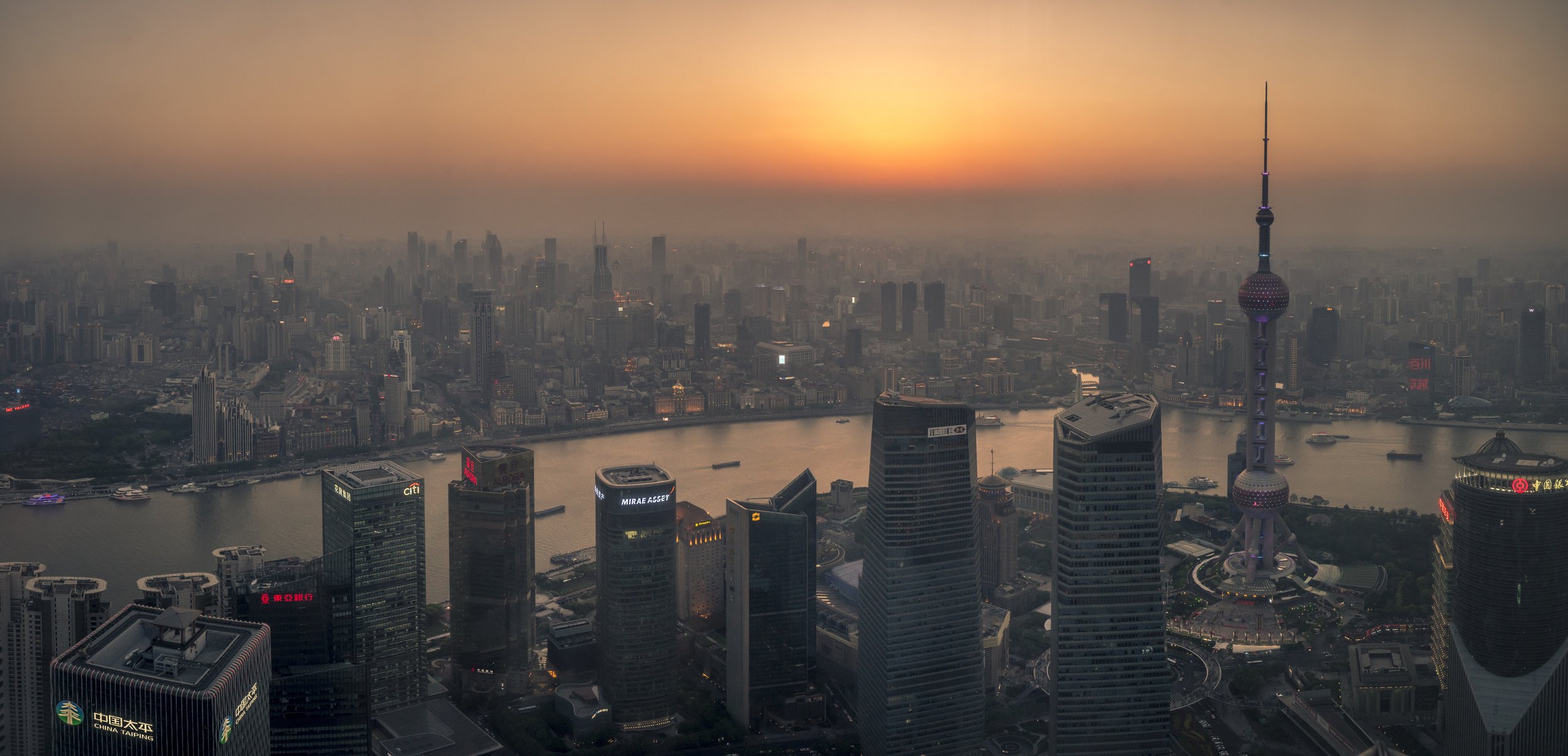  This photo was taken from the top of the Jin Mao Tower in Shanghai, a city which exemplifies the explosive growth and modernity that now exists in China. With growth this rapid, adverse effects are sure to follow. You can see that the sun looks as t