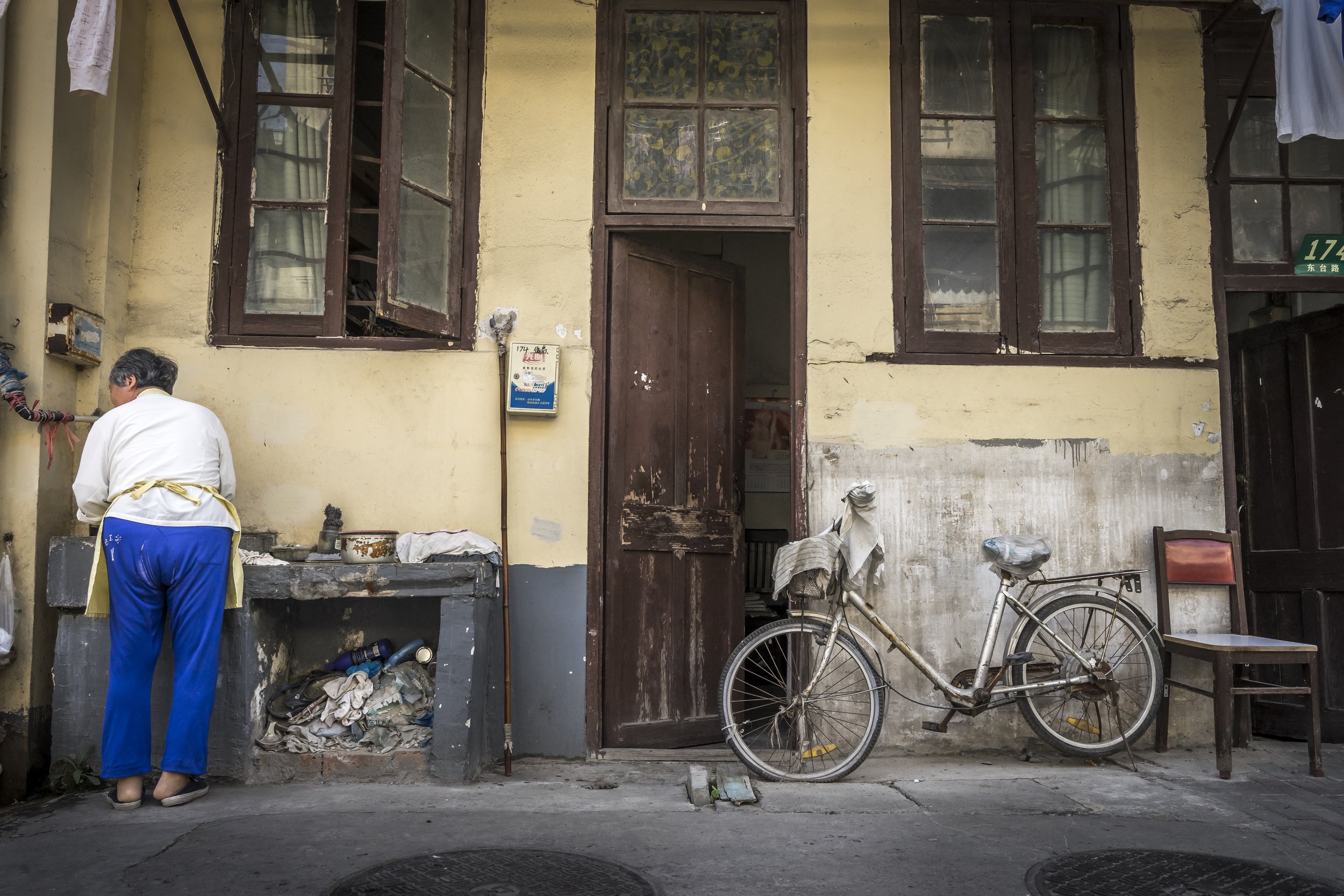  This photo was taken in one of the few remaining old districts of Shanghai’s downtown core. With the government's aggressive plan to modernize China’s skyline, many of these residents face forced evictions to make way for developments. In most cases