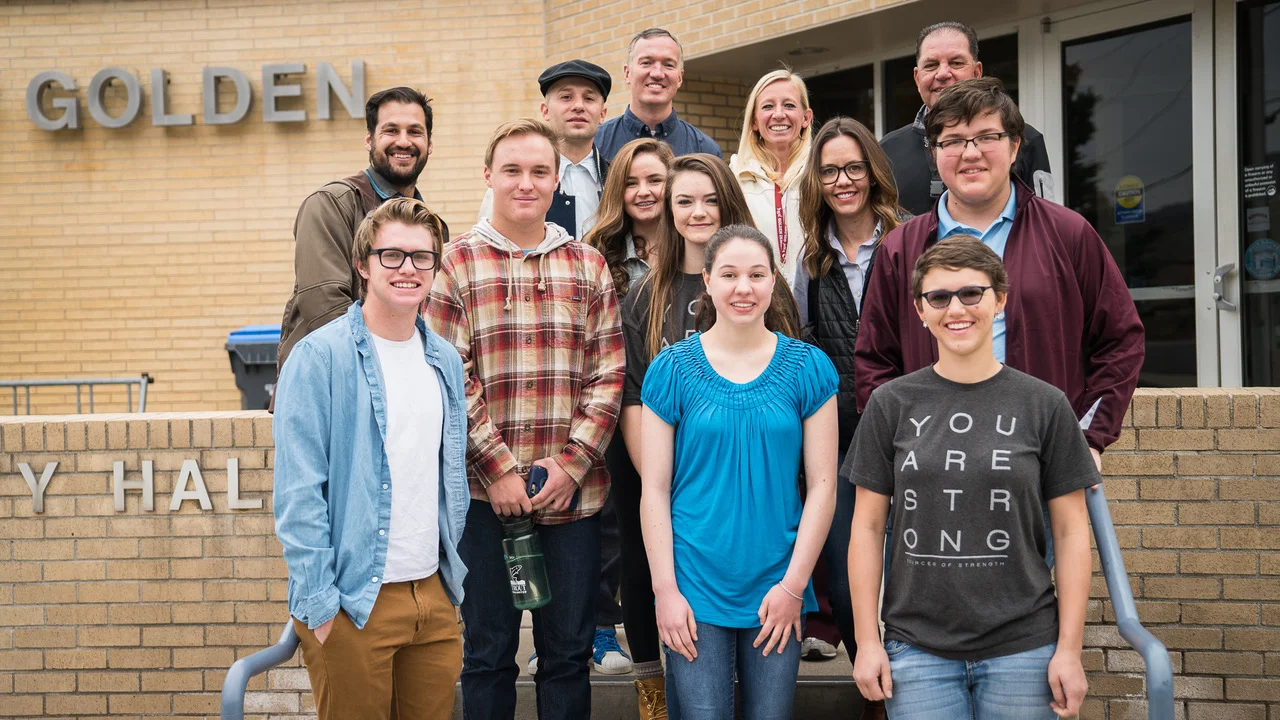 Foothills Art Center staff pose for a photo with students from Sources of Strength and local artist, Jolt.
