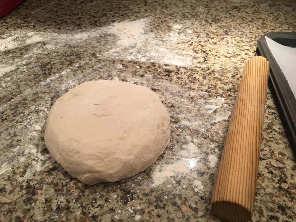 start with rolling out your dough ball. Now I screwed this part up. Move your rolled out dough to your sheet with parchment before slitting the sides!