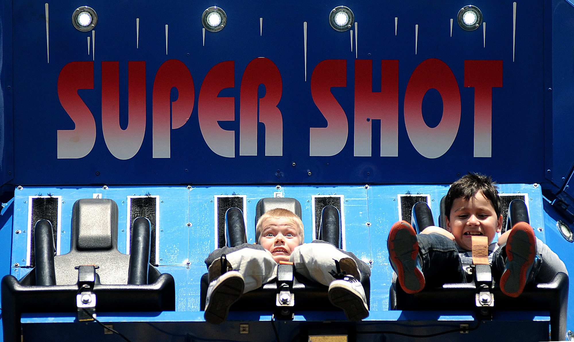 Christopher Frank, 8, of Northampton, middle, rides the "Super Shot" tower at the Lower Southampton Athletic Association annual carnival on Sunday, April 26, 2014.