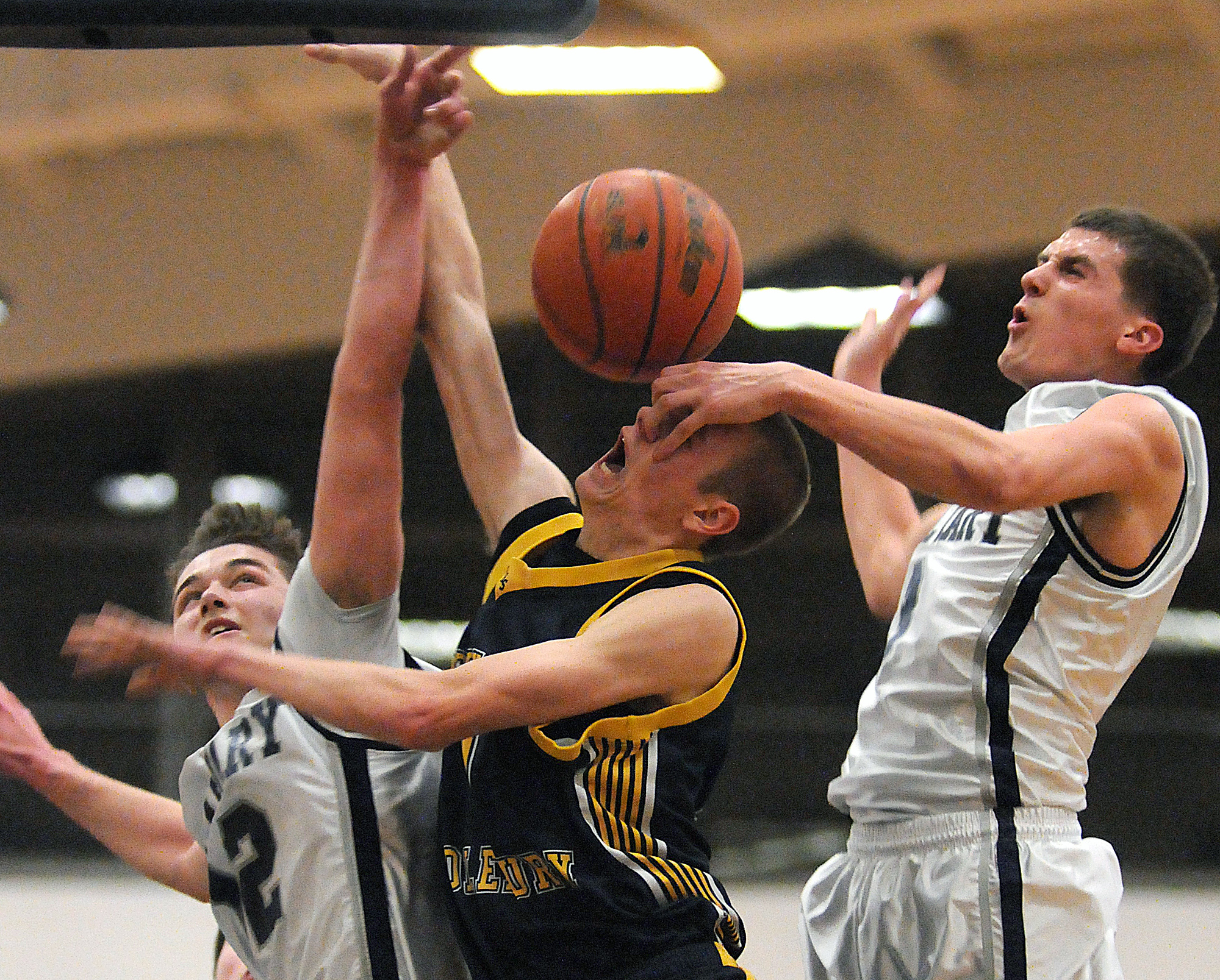 Calvary Christian's Sam Bair (12) and Jonathan Boback (3) try to block New Hope-Solebury's Jack Dougherty (1) from making a shot during New Hope-Solebury's three-point loss to Calvary Christian on Tuesday, Feb. 25, 2014 at Cheltenham High School. Calvary won 58-55.