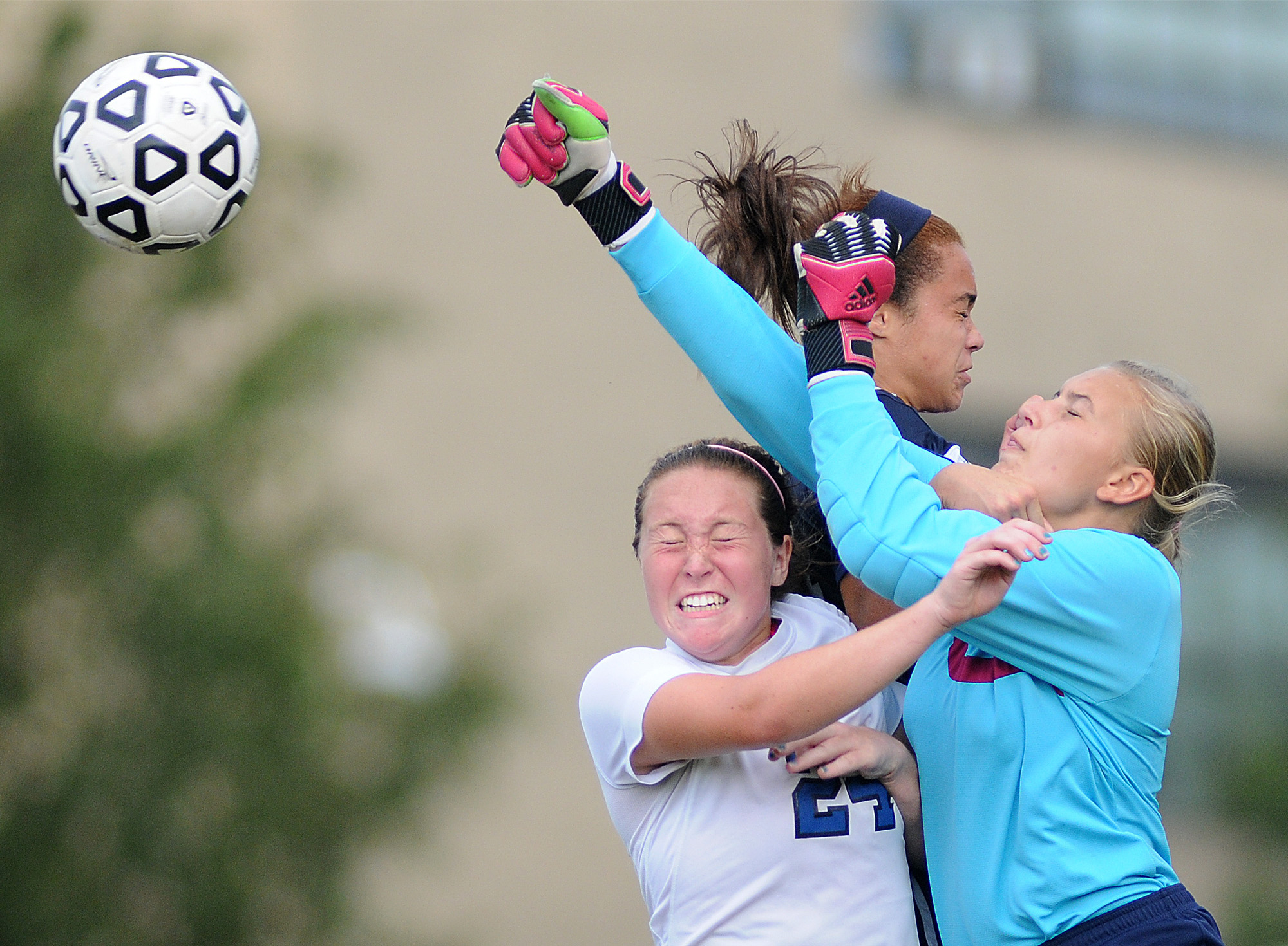 Cardinal O'Hara goal keeper Carrie Zamonski (31) punches the ball away from teammate Alex Patrick (24) and Conwell-Egan's Bailey Brown (24) during their game at Conwell-Egan Catholic High School in Bristol Township on Thursday, Sept. 11, 2014.