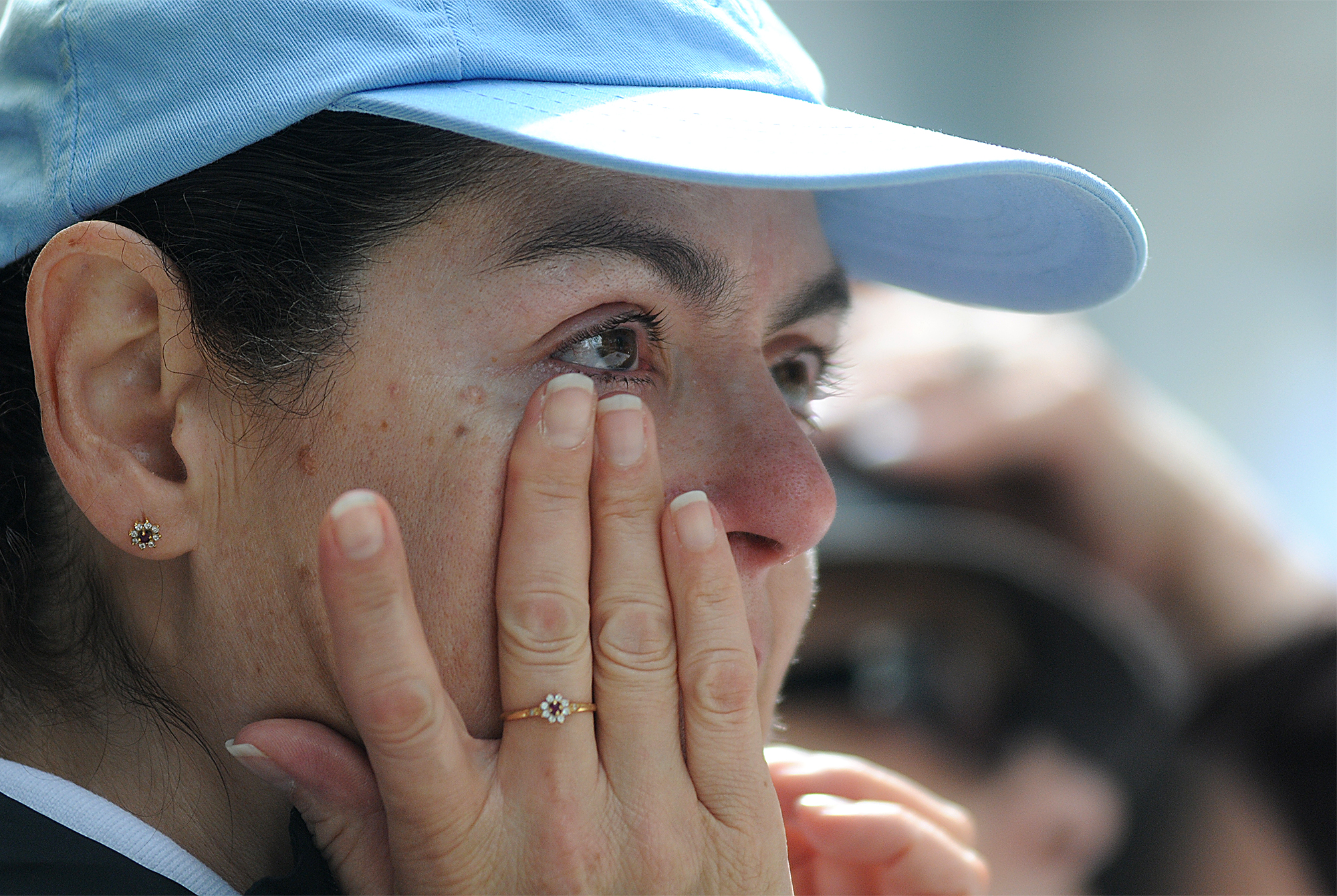  Consuelo Delgado of Browns Mills, New Jersey, wipes a tear while watching Pope Francis' mass at Cathedral Basilica of Saints Peter and Paul from jumbotrons on the Ben Franklin Parkway on September 26, 2015. 