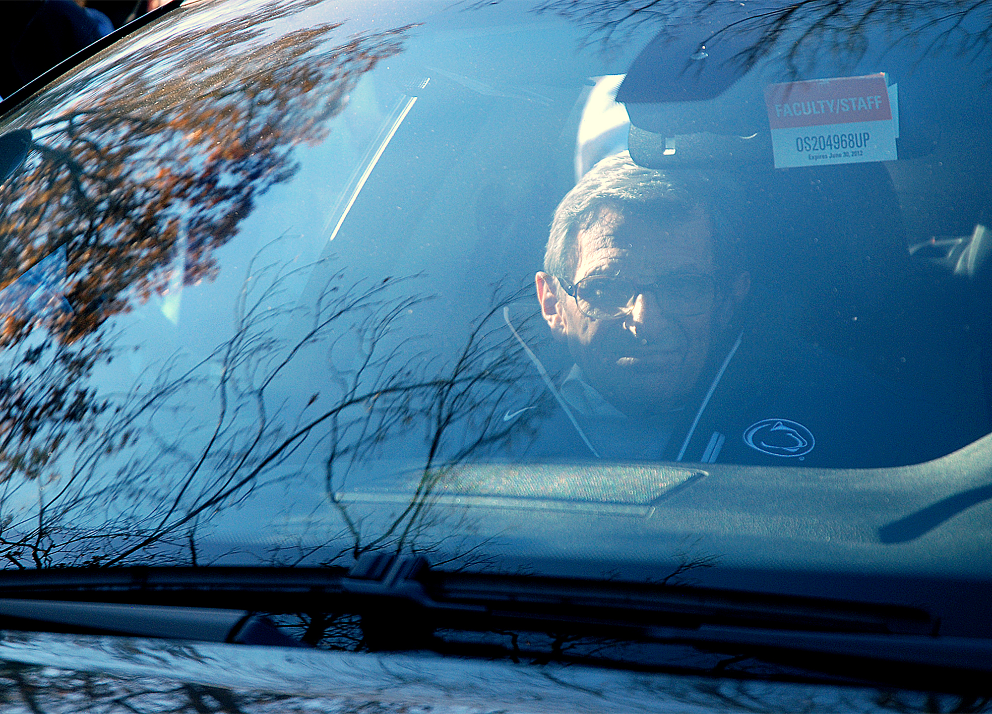  Penn State head coach Joe Paterno leaves his State College home with Guido D'Elia in his BMW on Tuesday afternoon. Media was staked outside of his home waiting for him to leave for football practice. 