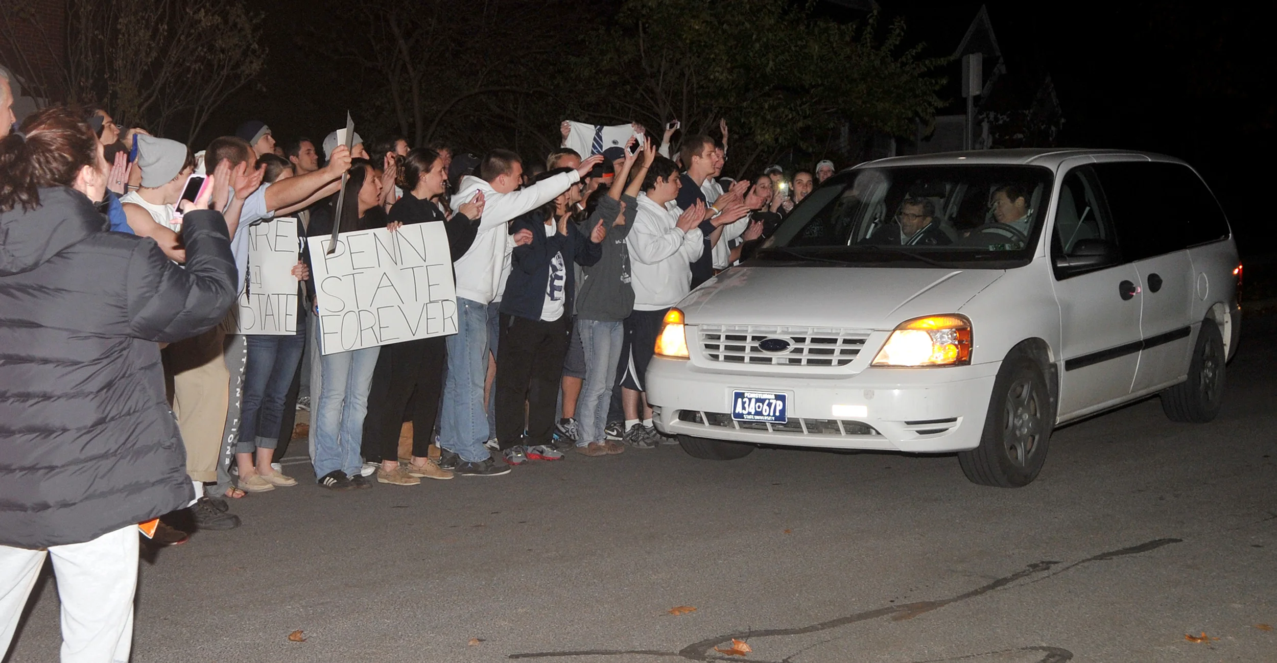 Head coach Joe Paterno is driven into his driveway after football practice on Tuesday night, where around 300 students gathered in support of Paterno.