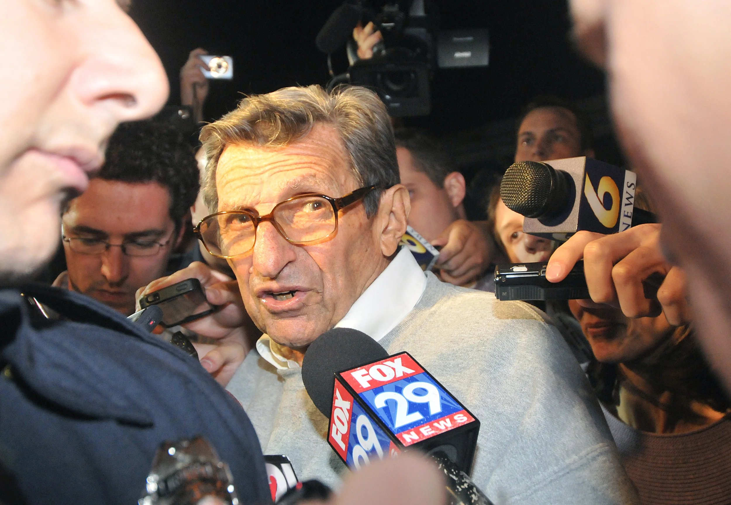 Head coach Joe Paterno speaks outside of his home in State College on Tuesday night to members of the media. A group of around 300 students gathered in support of Paterno, held signs, and sang the Alma Mater.