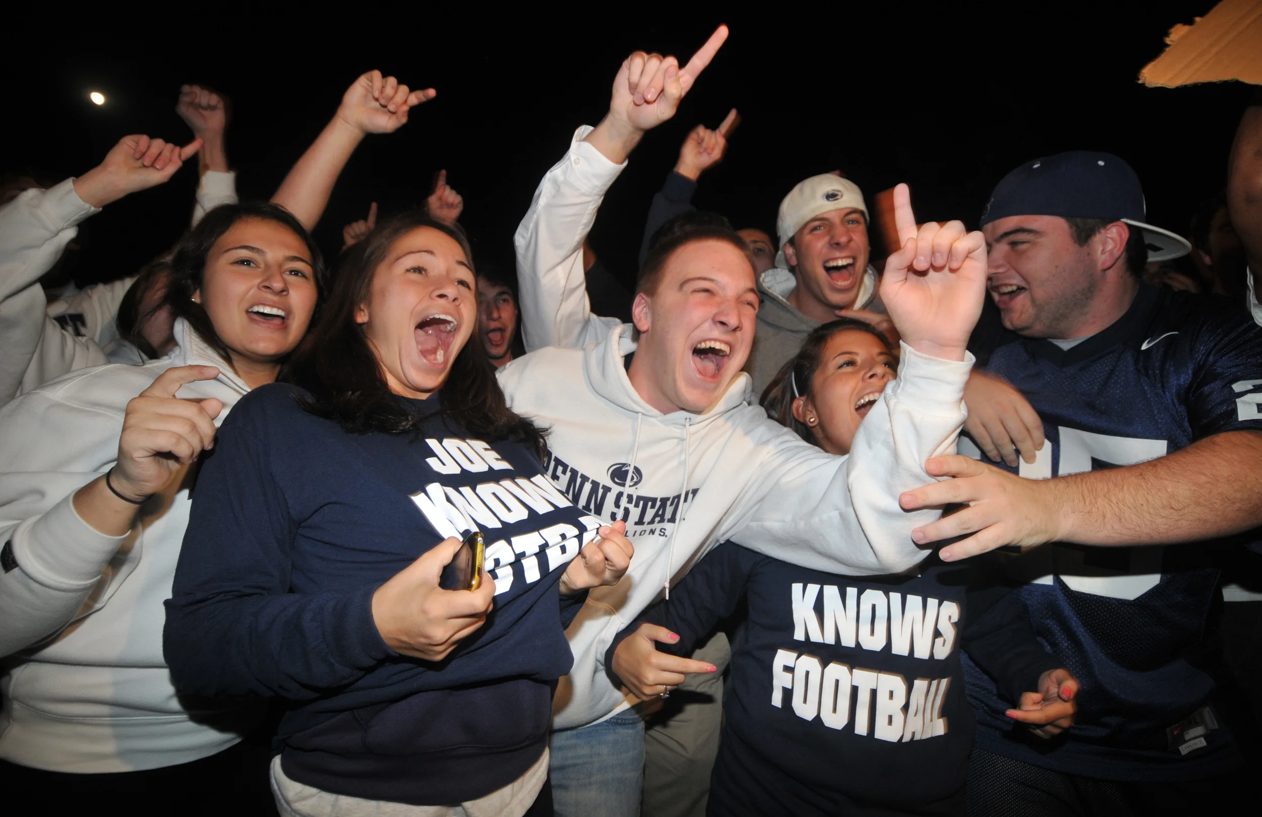 Students show their support for head coach Joe Paterno and their Penn State pride outside of Paterno's home in State College on Tuesday night. A crowd of around 300 chanted things such as "f*** the media," "beat Nebraska," and "Joe-pa-terno."
