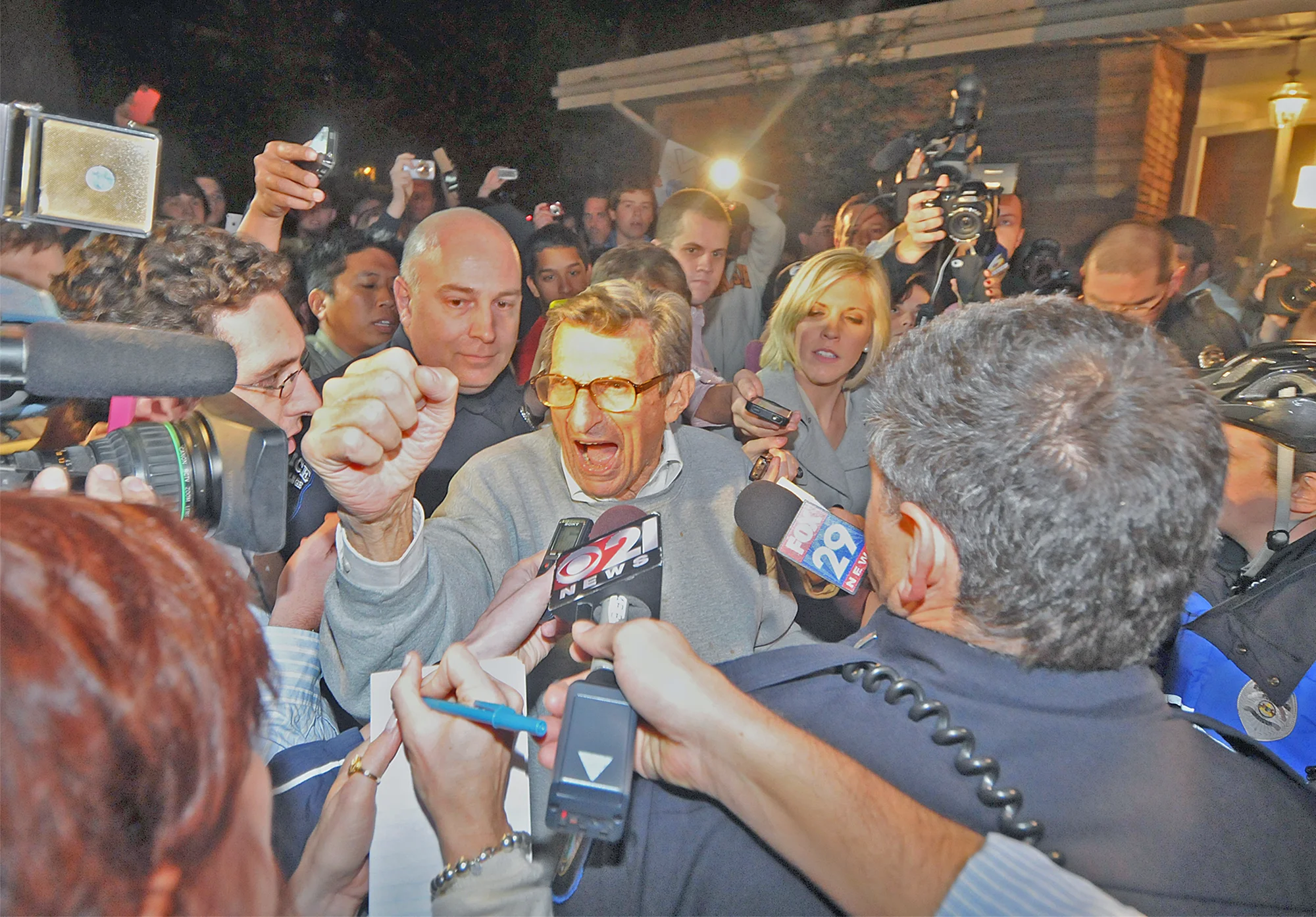 Head coach Joe Paterno finishes the "We Are" chant outside of his home in State College on Tuesday night. A group of around 300 students gathered in support of Paterno.