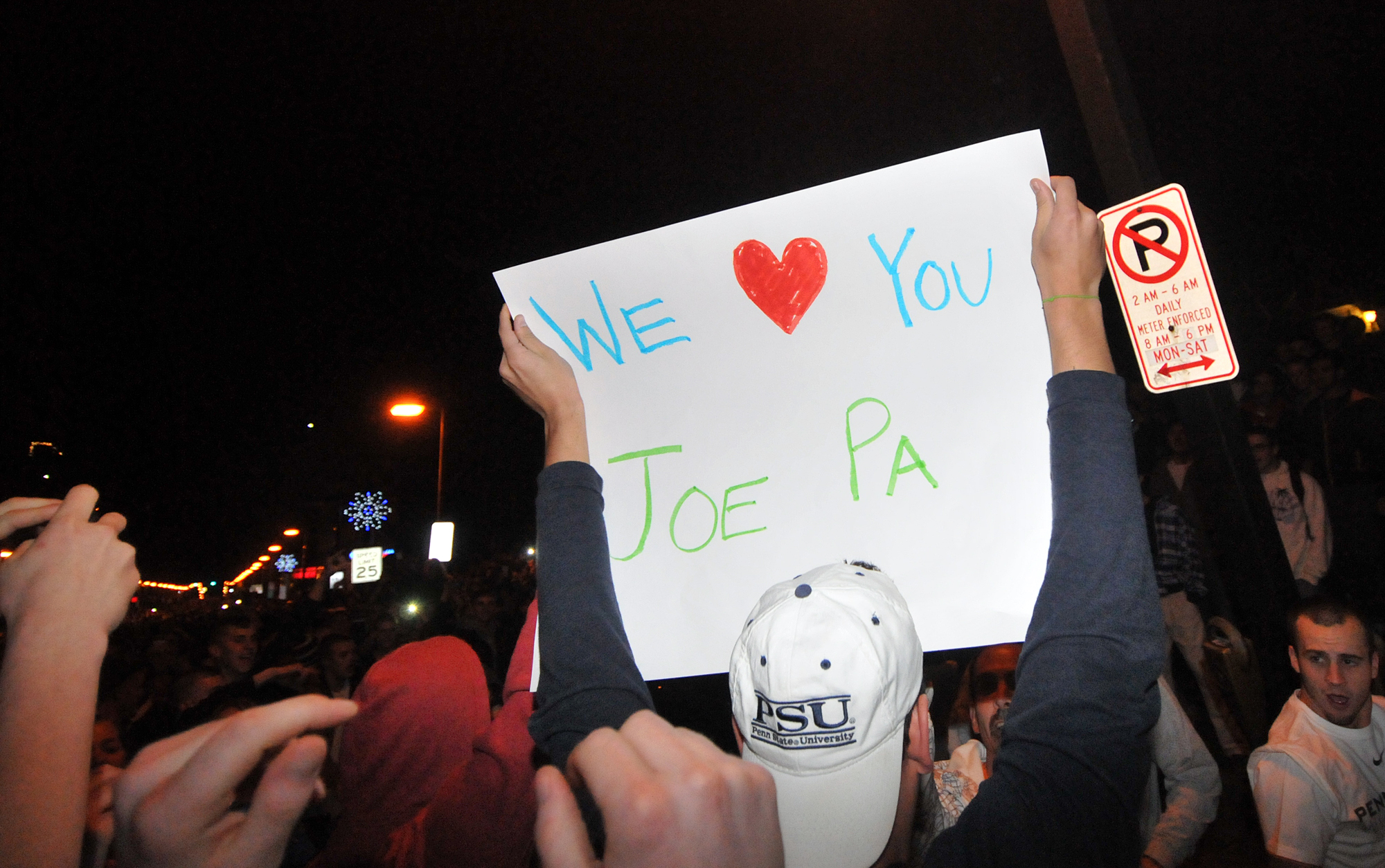  A student holds up a sign during the riot in Beaver Canyon in downtown State College on Wednesday night. 