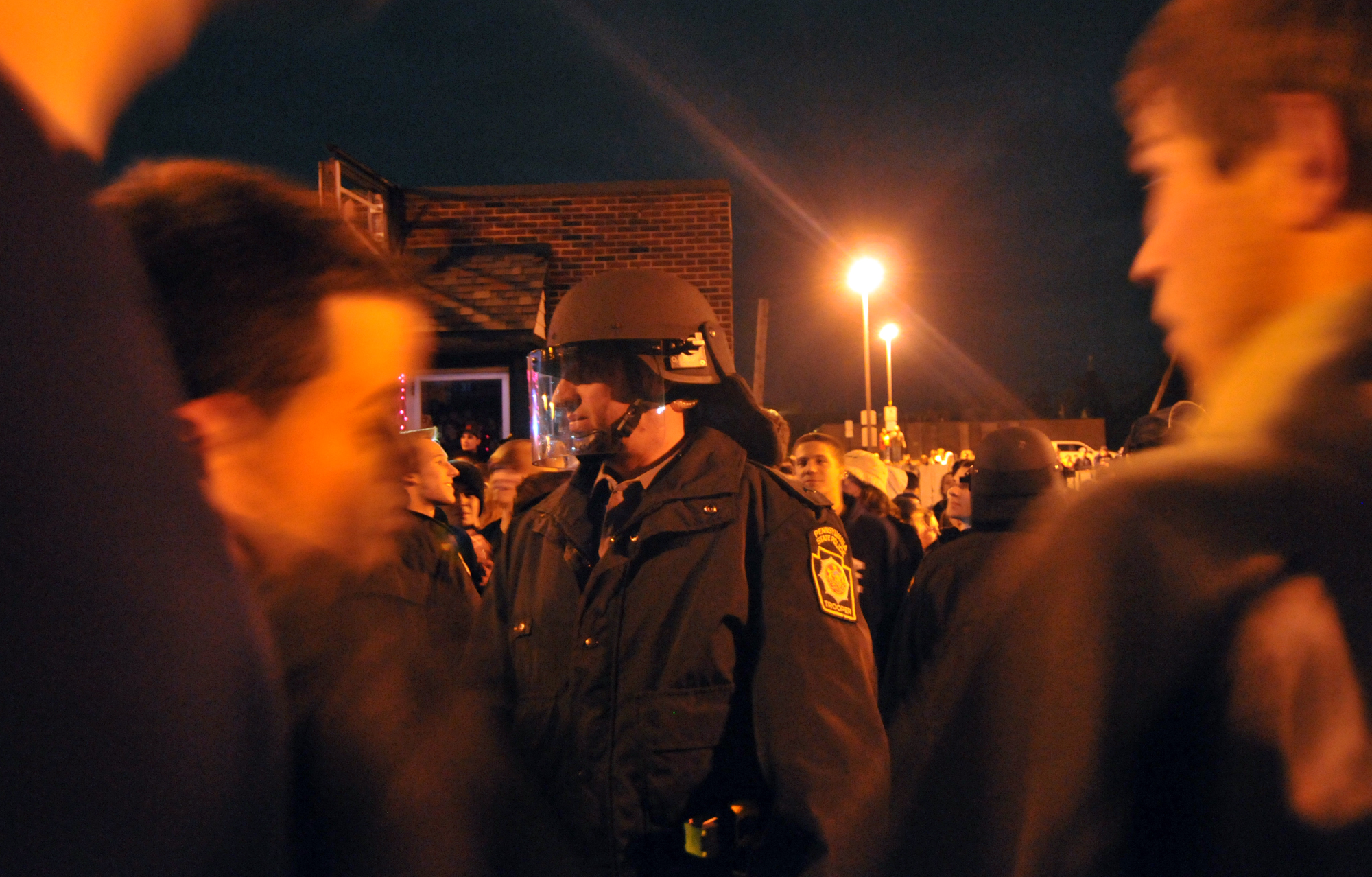  A riot policeman stands in line with others to block students from the road on Beaver Avenue during the riots on Wednesday night. The policemen, armed with nightsticks, mace and pepper spray formed lines to keep students on the sidewalks and off the