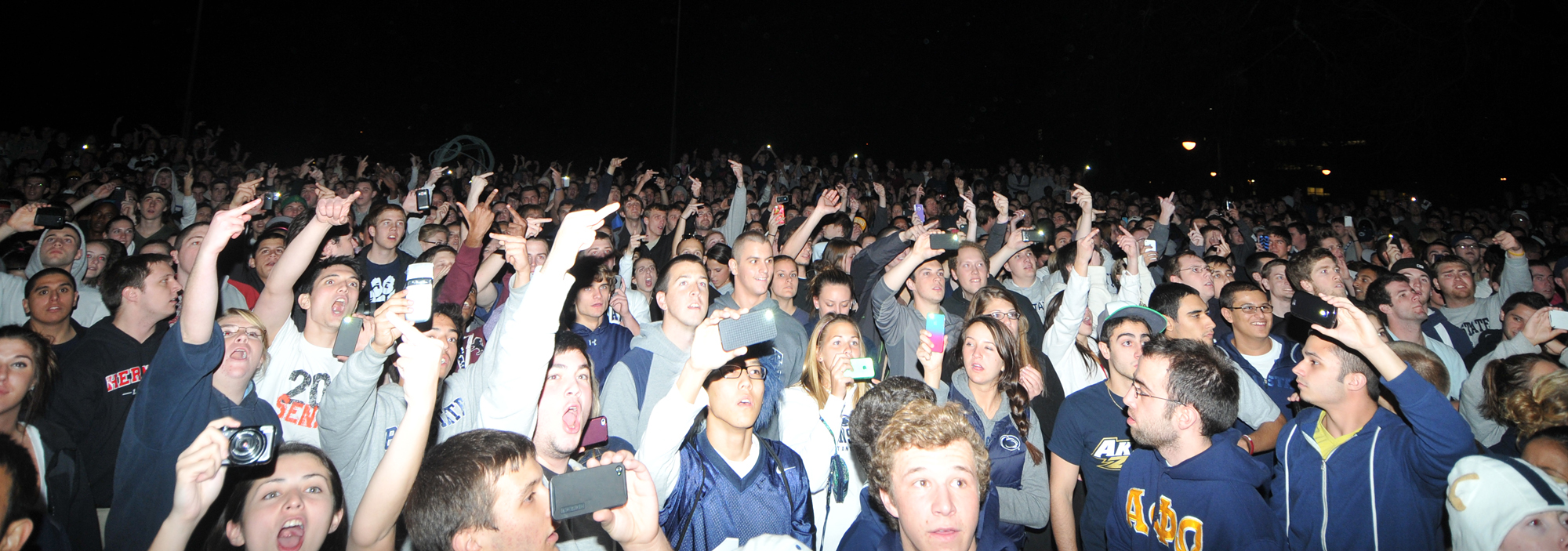  Rioters gather in front of Old Main on Wednesday night and listen to a person with a megaphone before heading down to Beaver Avenue. 