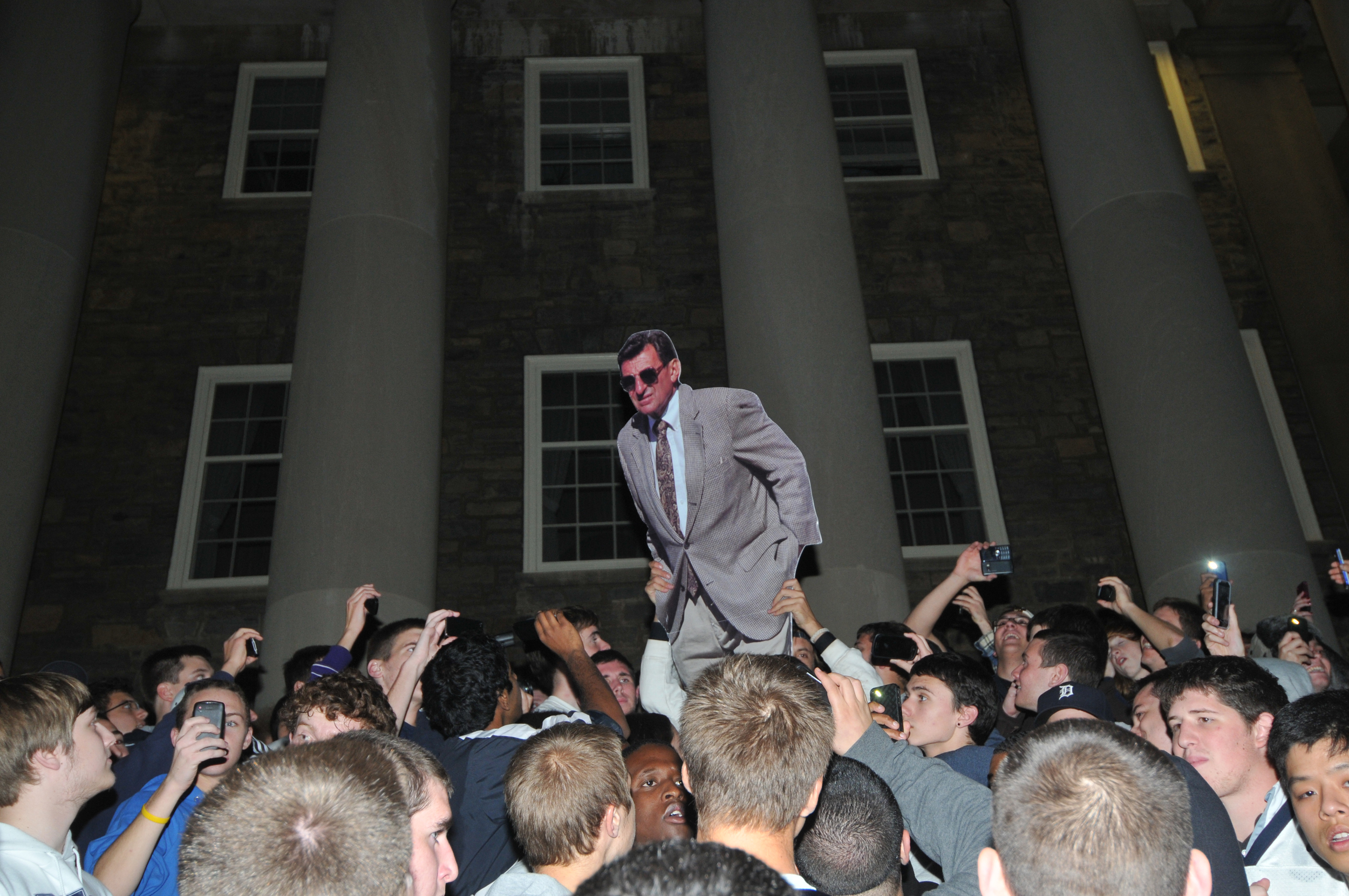  Students riot with a cardboard Joe Paterno on the steps of Old Main on Wednesday night in response to his termination as the head coach of football. 