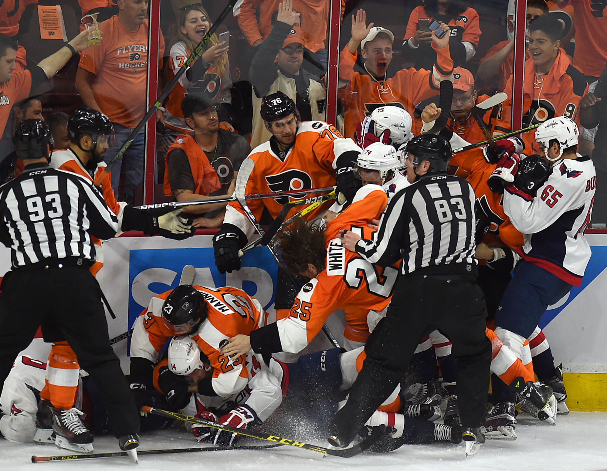 Flyers player Ryan White (25) falls down in the middle of a huge pile of fighting players from both teams during their playoff game against the Capitals at The Wells Fargo Center on Monday, April 18, 2016. The Flyers lost 6-1, but went on to win two more games against the Caps in their seven-game series.