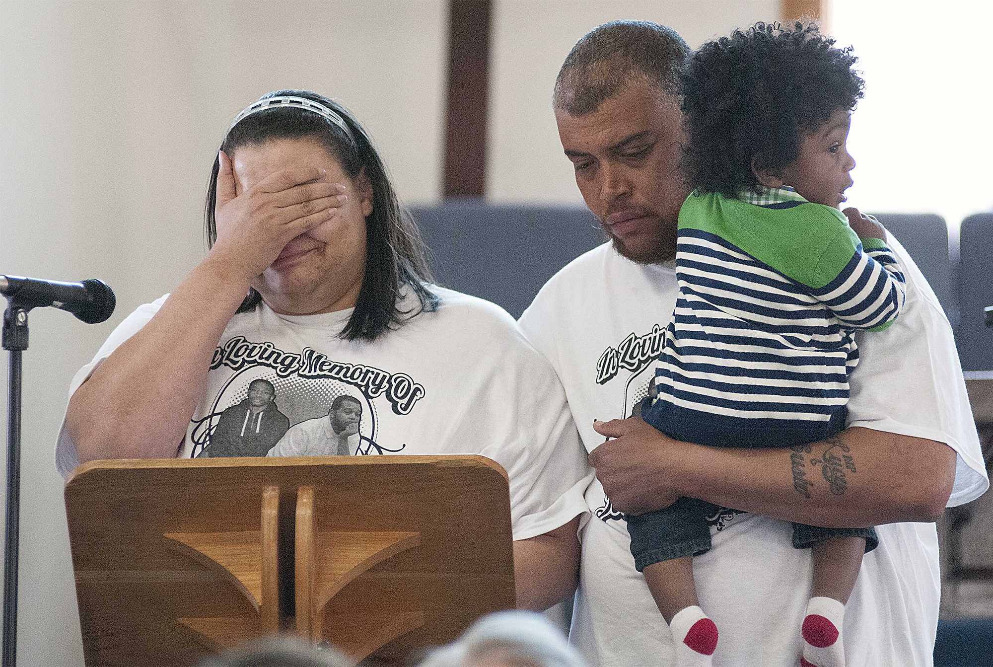  Te-Shawn Wilson, the sister of 2014 triple-shooting victim Tyrone Moss, is overcome with emotion while standing with Vincent Moss and little cousin Josiah McClain, 1, while trying to speak to the group gathered at the House of Prayer Church in Brist