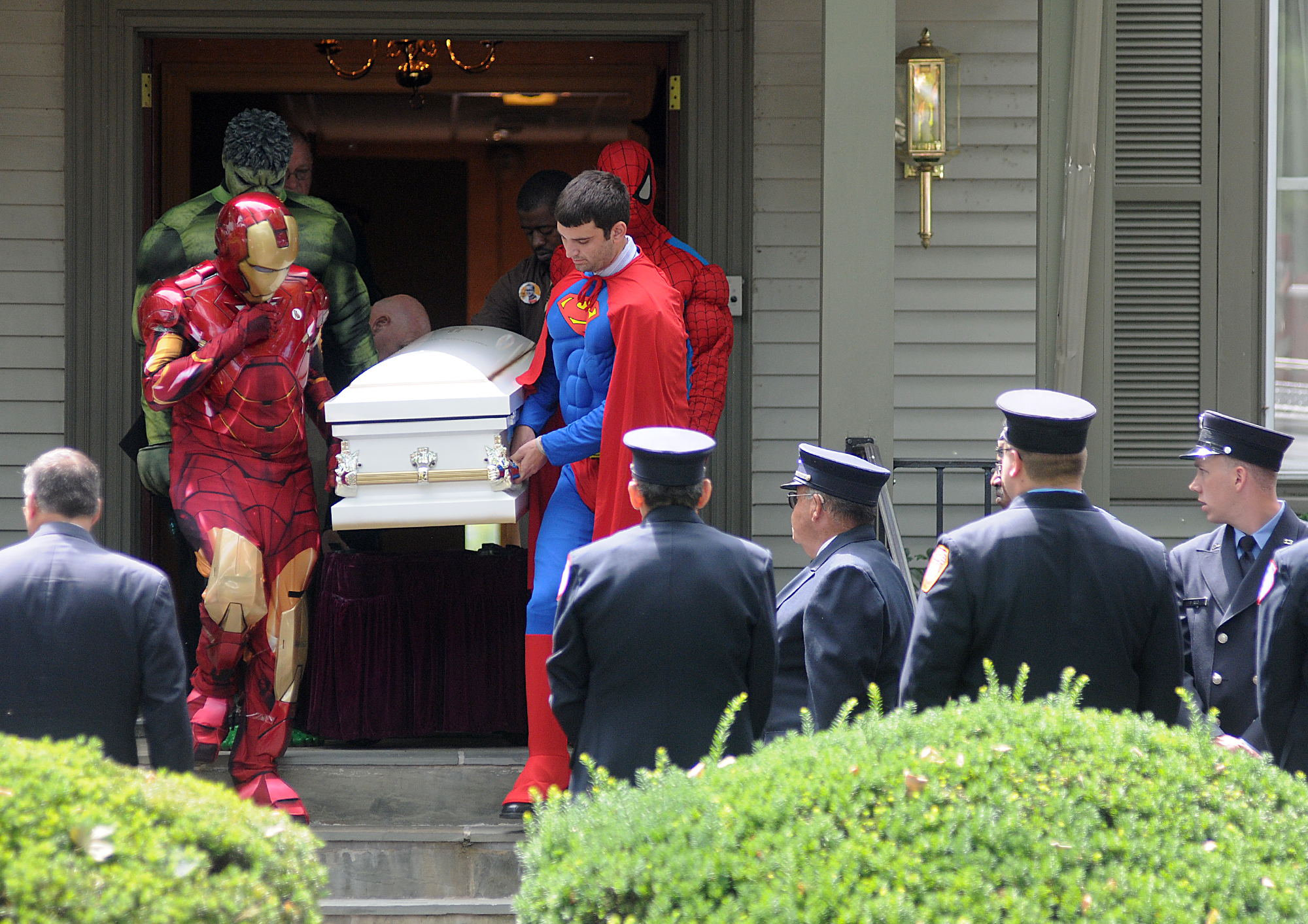  The casket of 5-yr-old Franky Talley is escorted from the Hooper Funeral Home on W. Trenton Avenue in Morrisville by pallbearers dressed as superheroes to a mass at St. John the Evangelist in Morrisville before a burial at the Holy Trinity Cemetery 