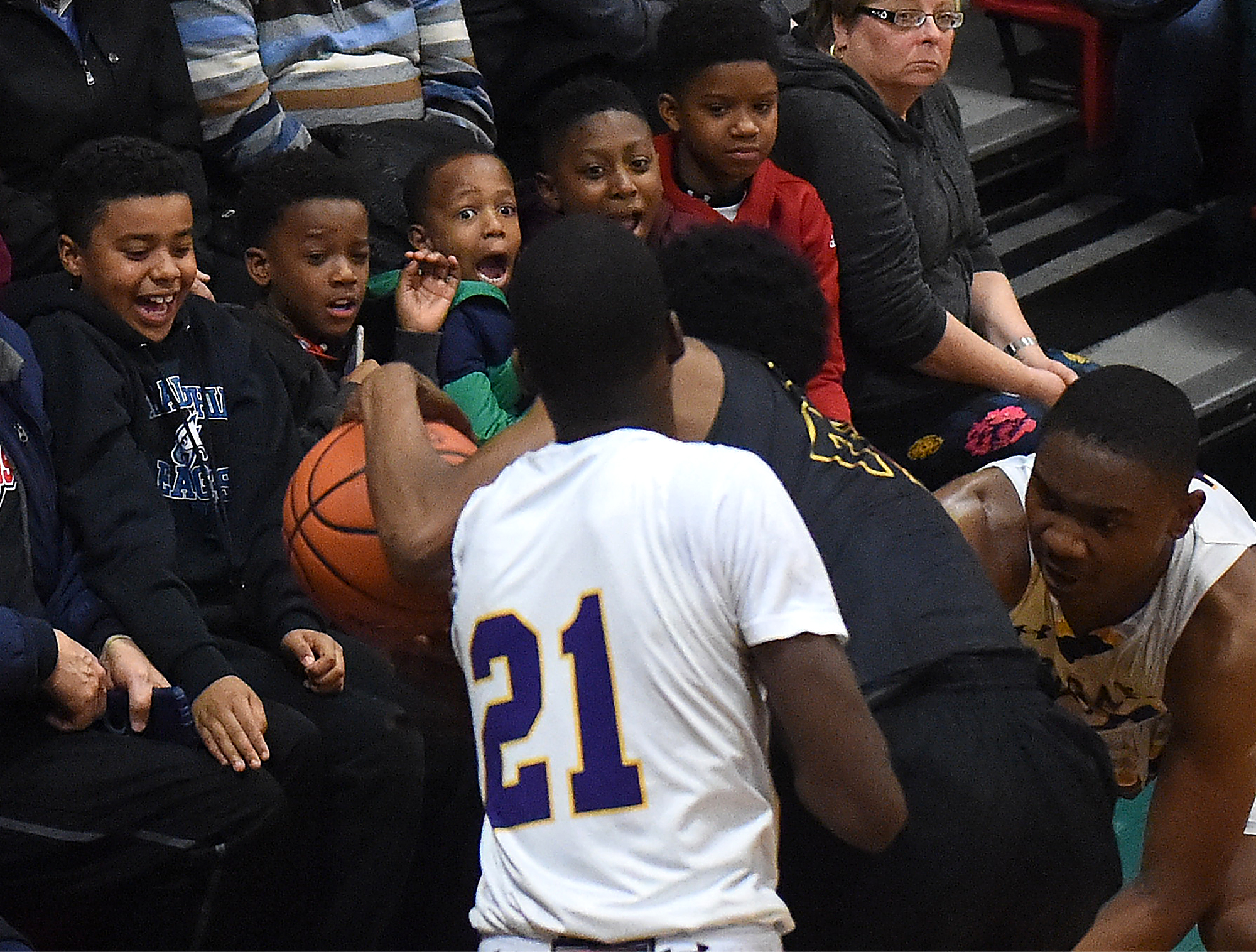  A group of boys react to players losing control of the ball in front of them during the District 12 AAAAA title game of Archbishop Wood against Martin Luther King High School at Father Judge High School in Northeast Philadelphia. Wood won the game 8