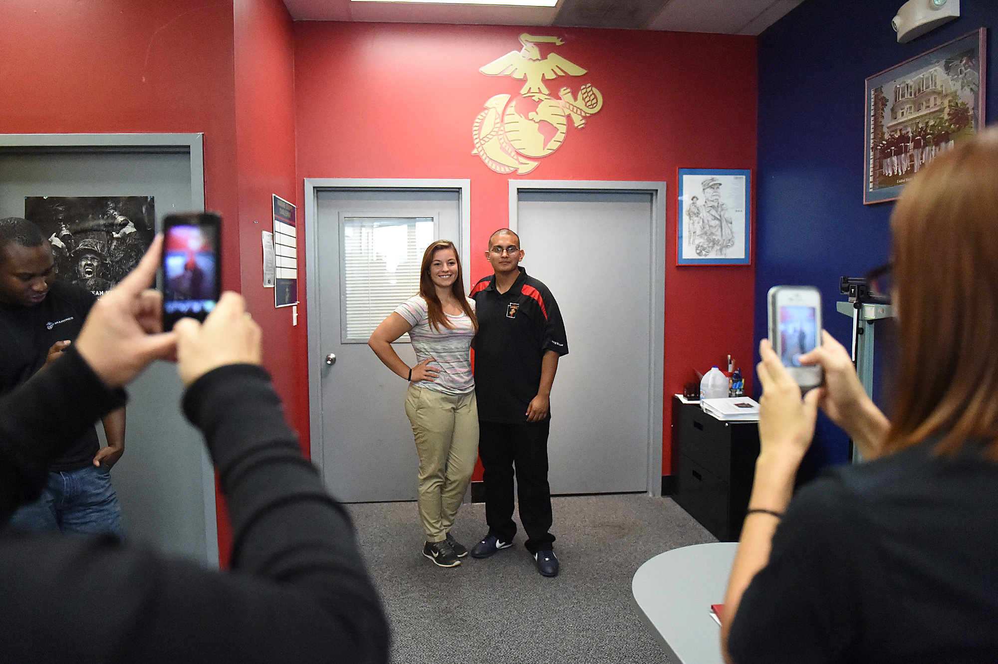  Dee Hubay poses for pictures with Sgt. Kevin Sanchez of the Marine Recruiting Sub Station Oxford Valley in Bristol Township (who has since switched stations) before leaving for boot camp at the US Marine Corps Recruiting station on Cottman Avenue in