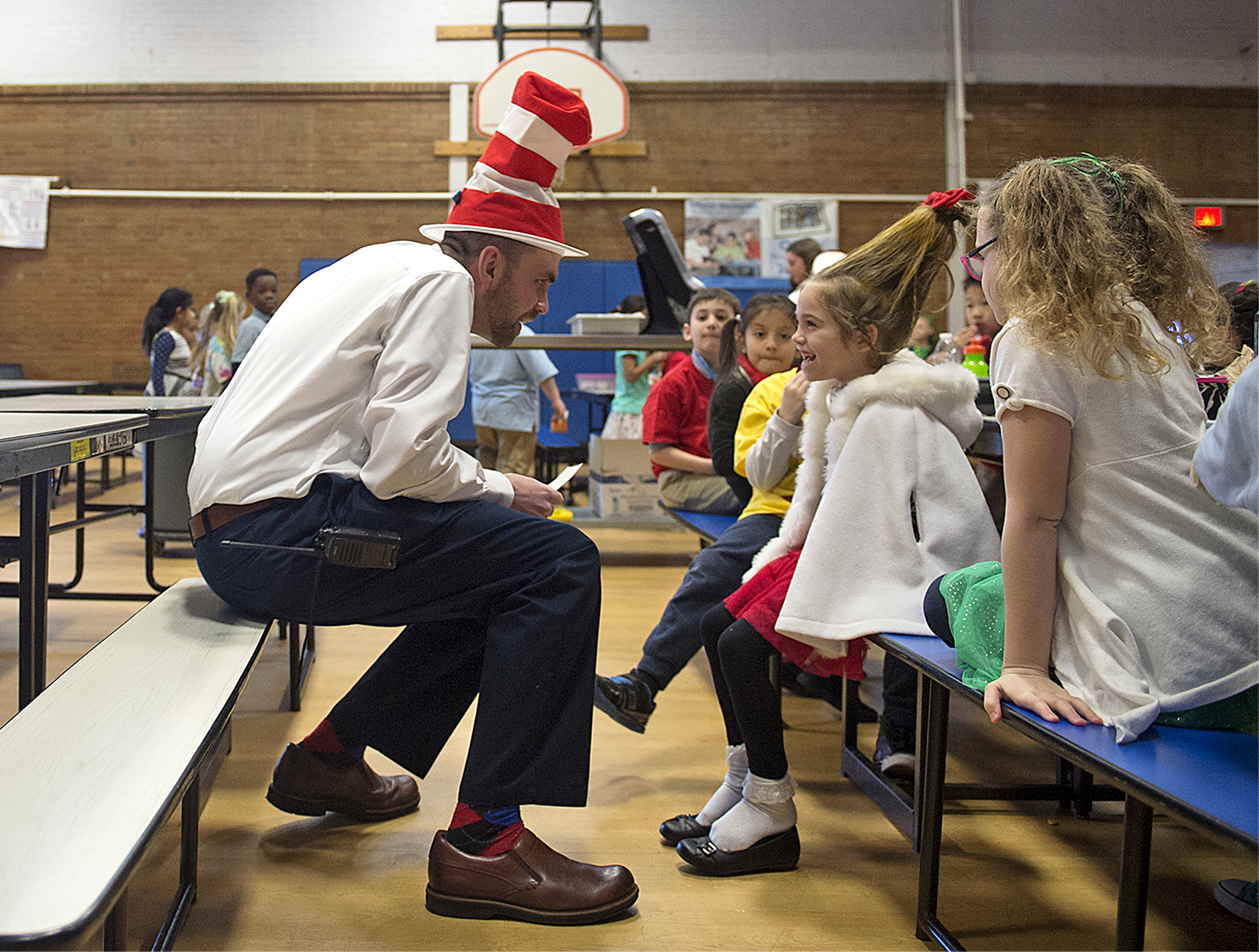  School Lane Charter School Vice Principal Jim Munizza, dressed as The Cat in the Hat, talks to first grader Kiersten, 6, in costume as Cindy Lou Who, before reading Oh, the Places You'll Go! to her class while celebrating Dr. Seuss' birthday at Scho