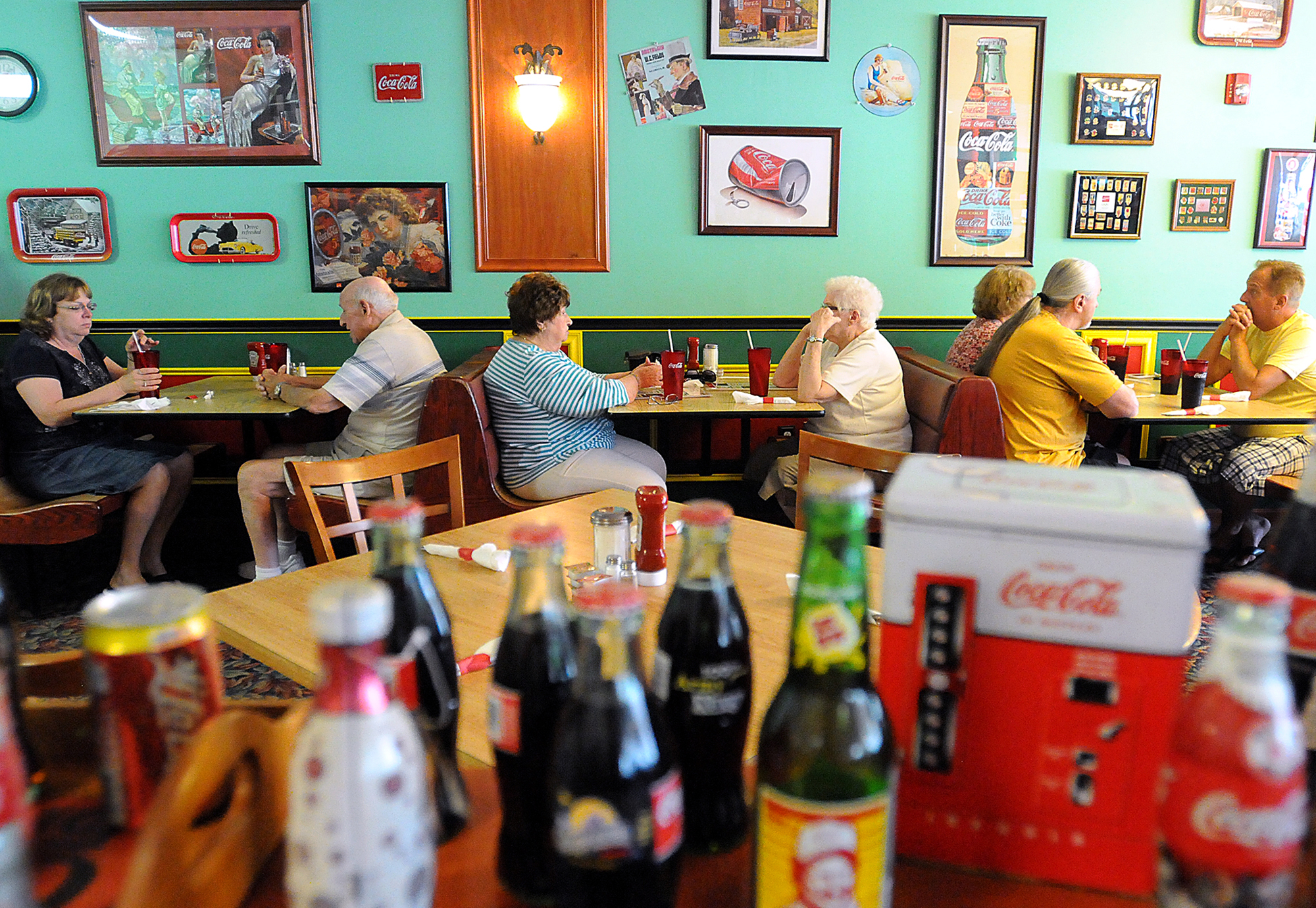  Customers eat at the Coca-Cola-themed Maryanne's Homestyle Cooking, which has reopened in Middletown Township after a fire last year at its location in Croydon. The restaurant has been in business for 27 years. 