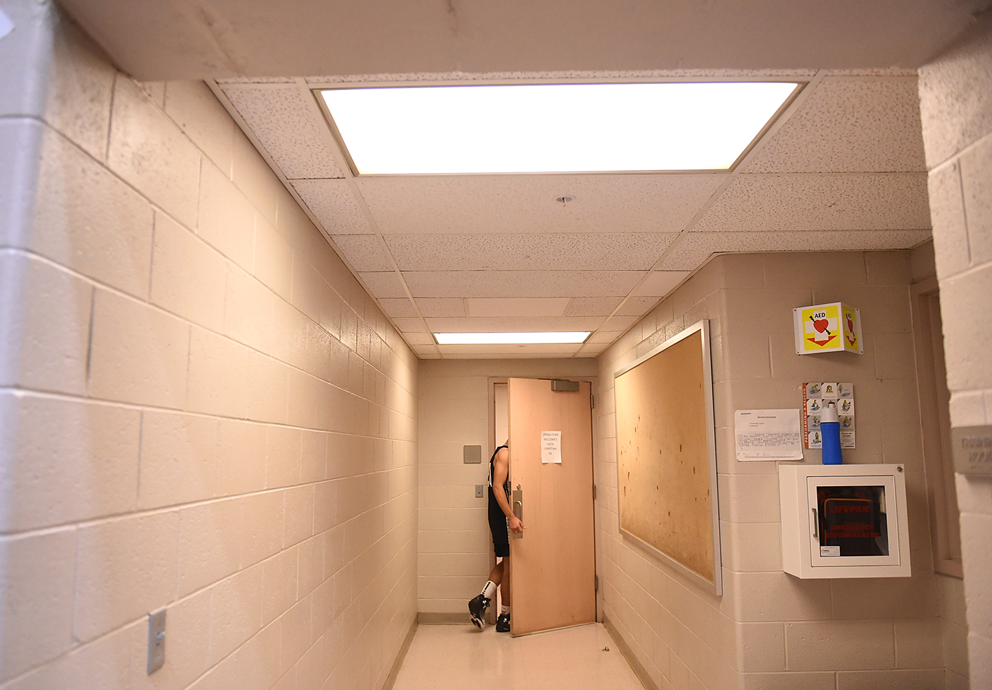  Faith Christian's Charles Ervin (20) is the last to the locker room after pausing to take a moment to himself after a 67-58 loss to Girard College during their PIAA Class A boys basketball semifinal game at Spring-Ford High School in Royersford.  Th