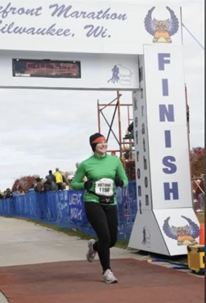Crossing my first marathon finish line in 2012, Milwaukee Lakefront Marathon 