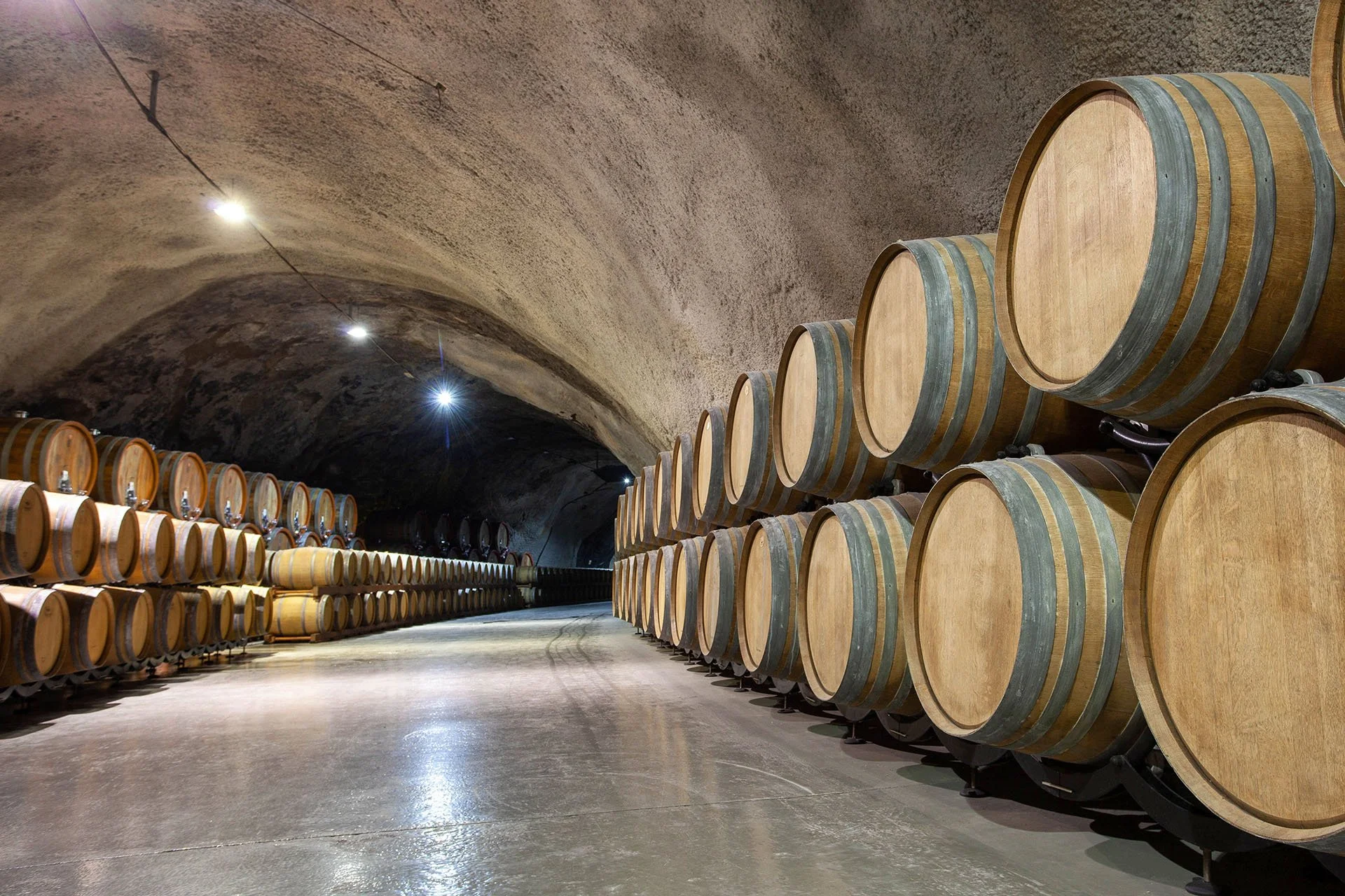 Why do California wineries build wine caves?