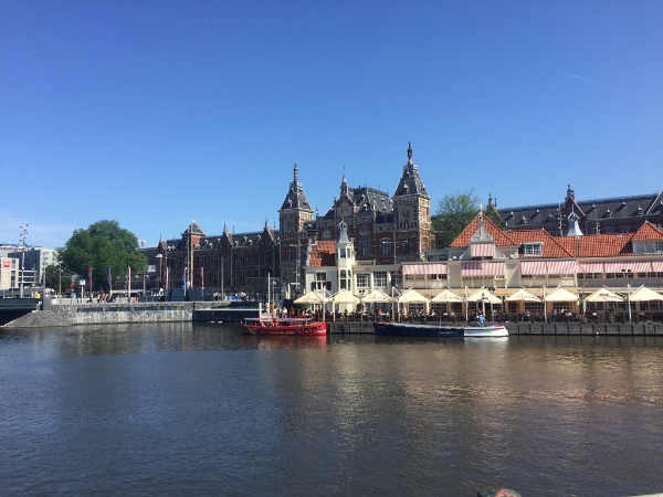 One of the many canals in Amsterdam, with some of the city's stately architecture behind