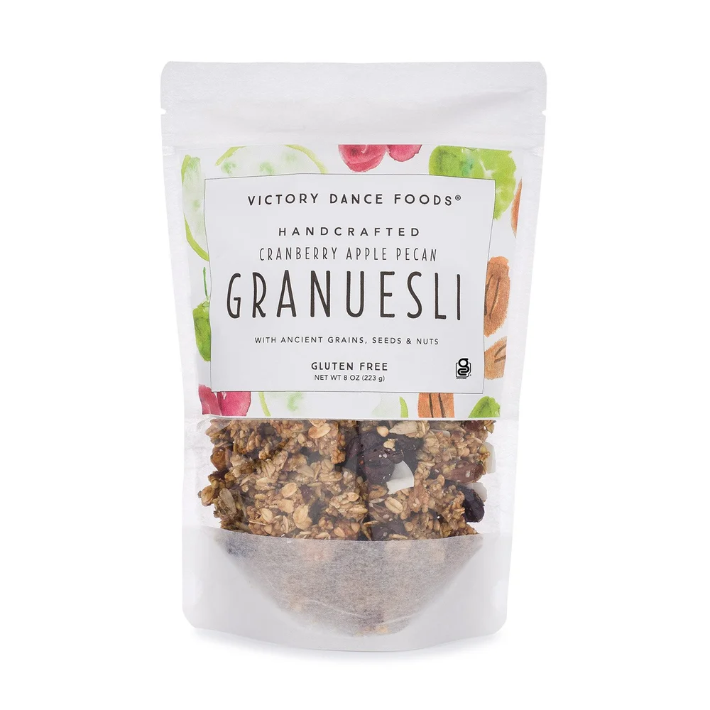 Front of Victory Dance Foods Granuesli® Cranberry Apple Pecan 8 oz bag, featuring visible granola clusters with pecans, dried cranberries, and apple pieces.
