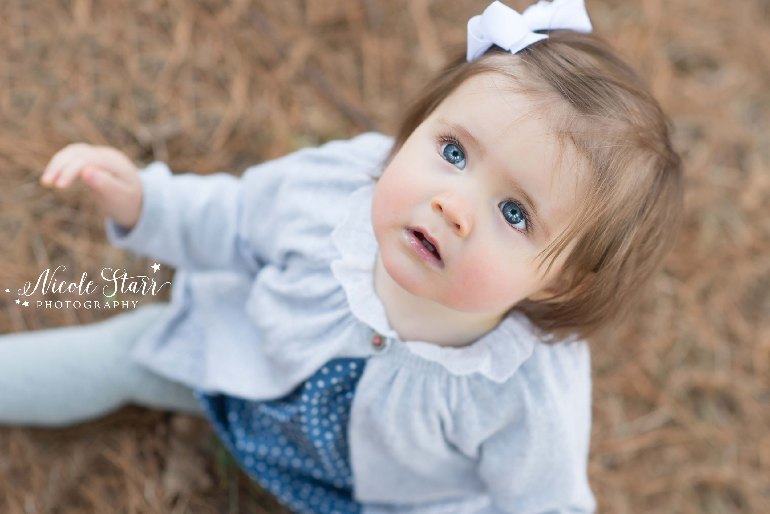 outdoor family photo session baby girl with big blue eyes.jpg