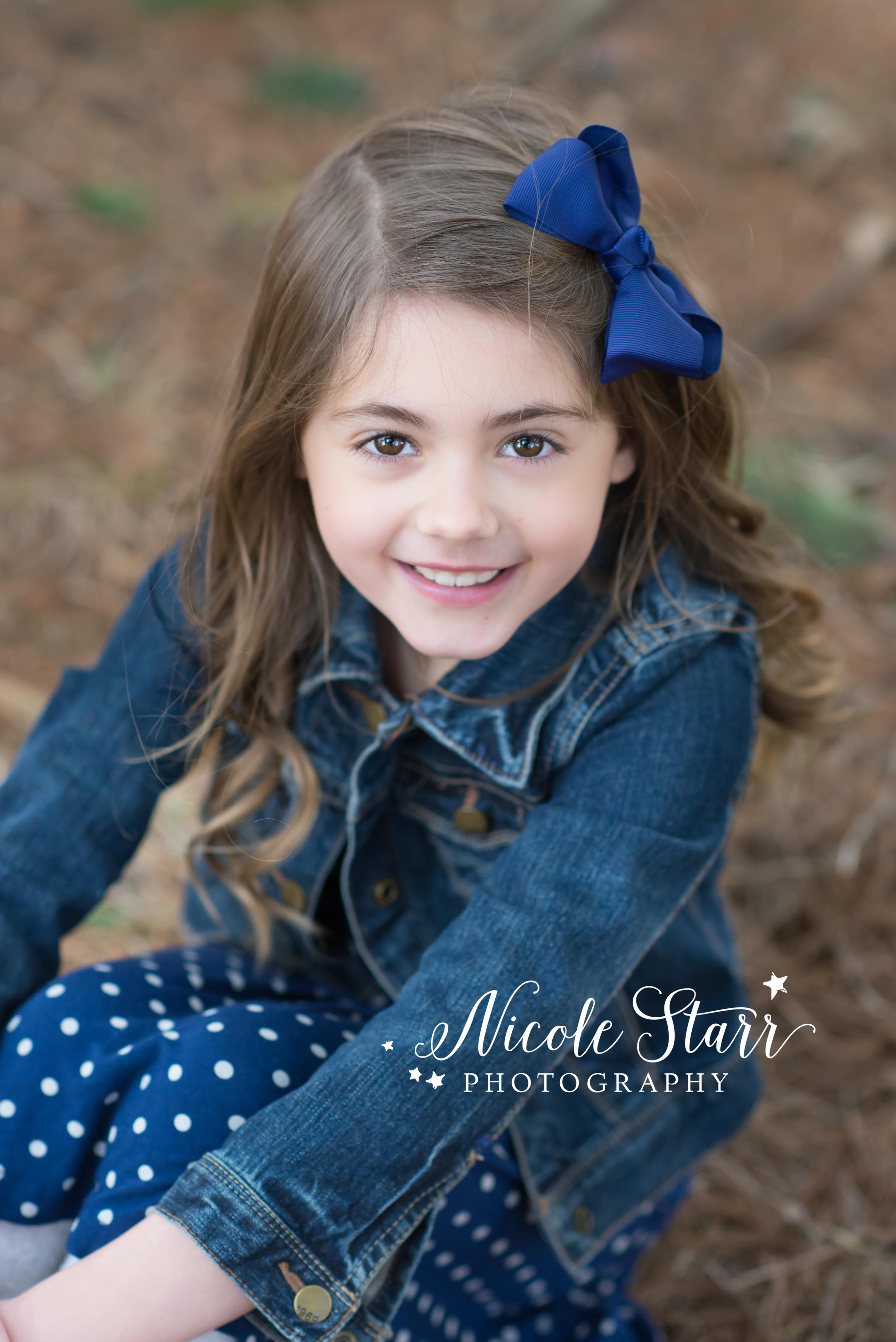 little girl with a jean jacket for a rustic photo session.jpg