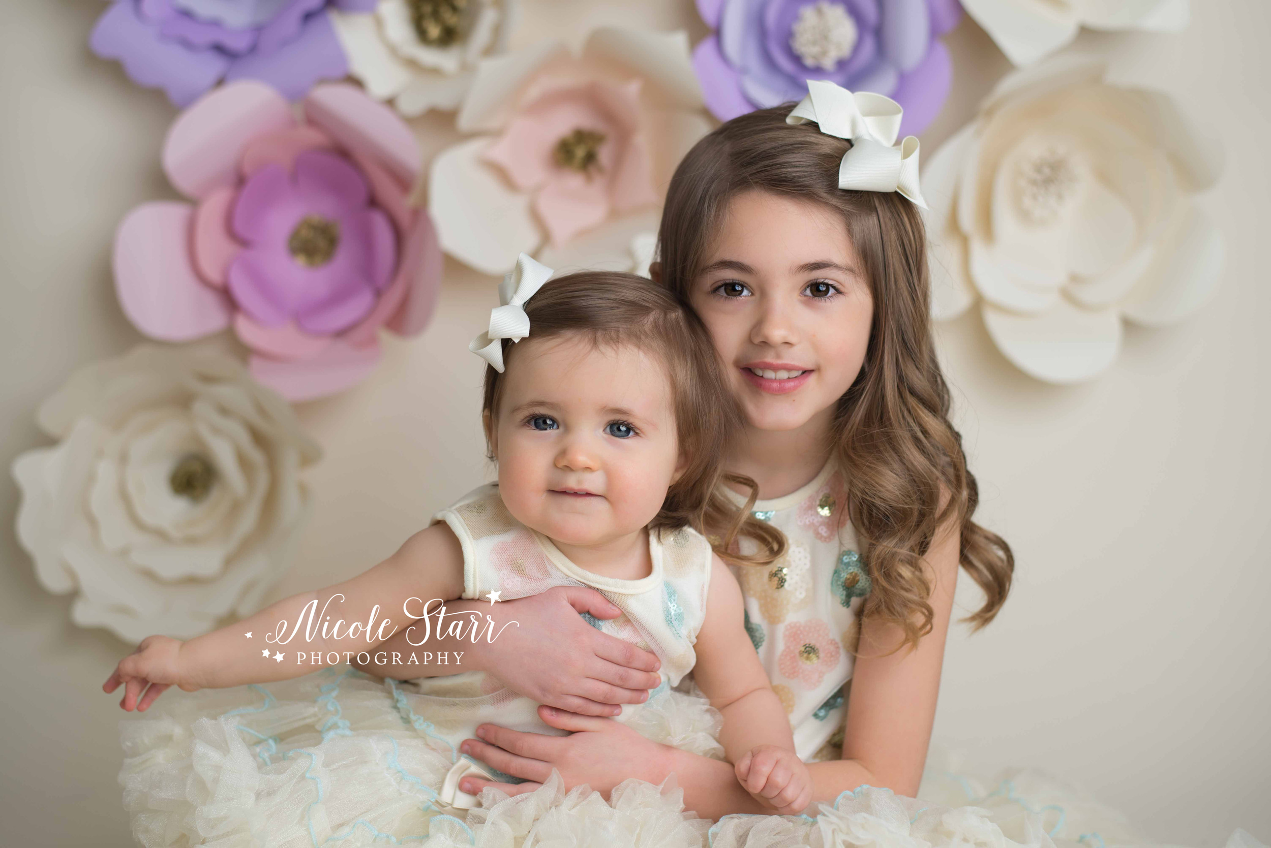 sisters with pastel colors and a floral spring studio session.jpg