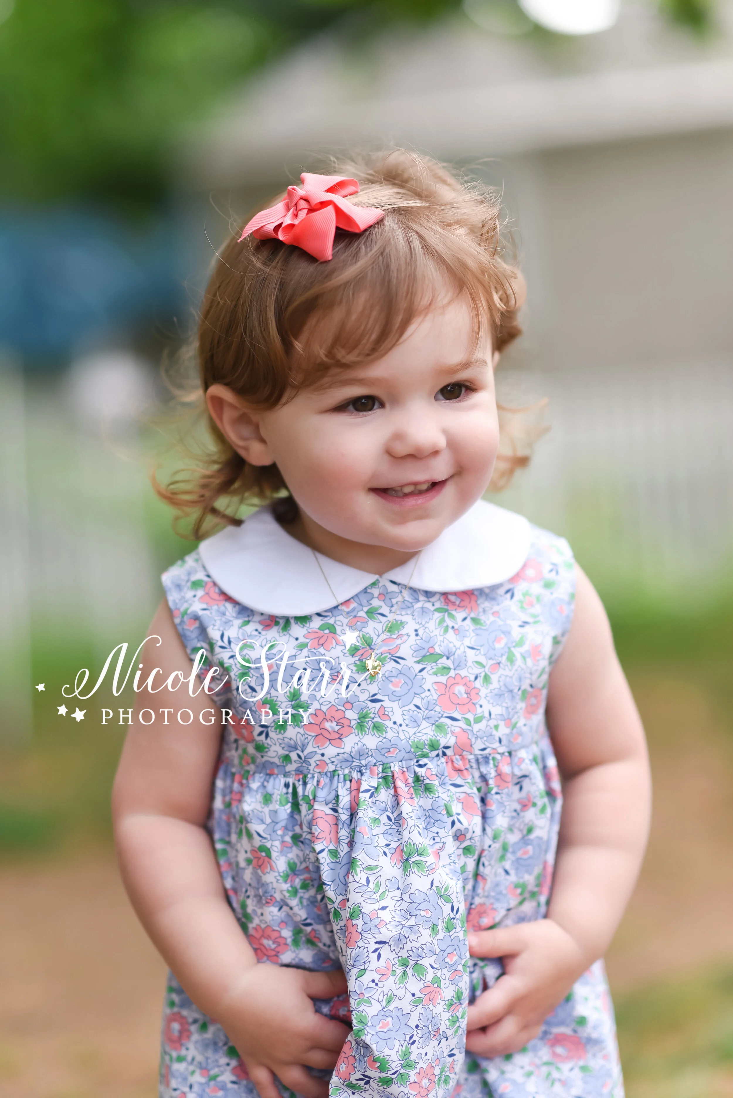 Toddler smiles at parents during Cape Cod portraits photographed by Cape Cod family and beach photographer Nicole Starr Photography | Classic Cape Cod portraits