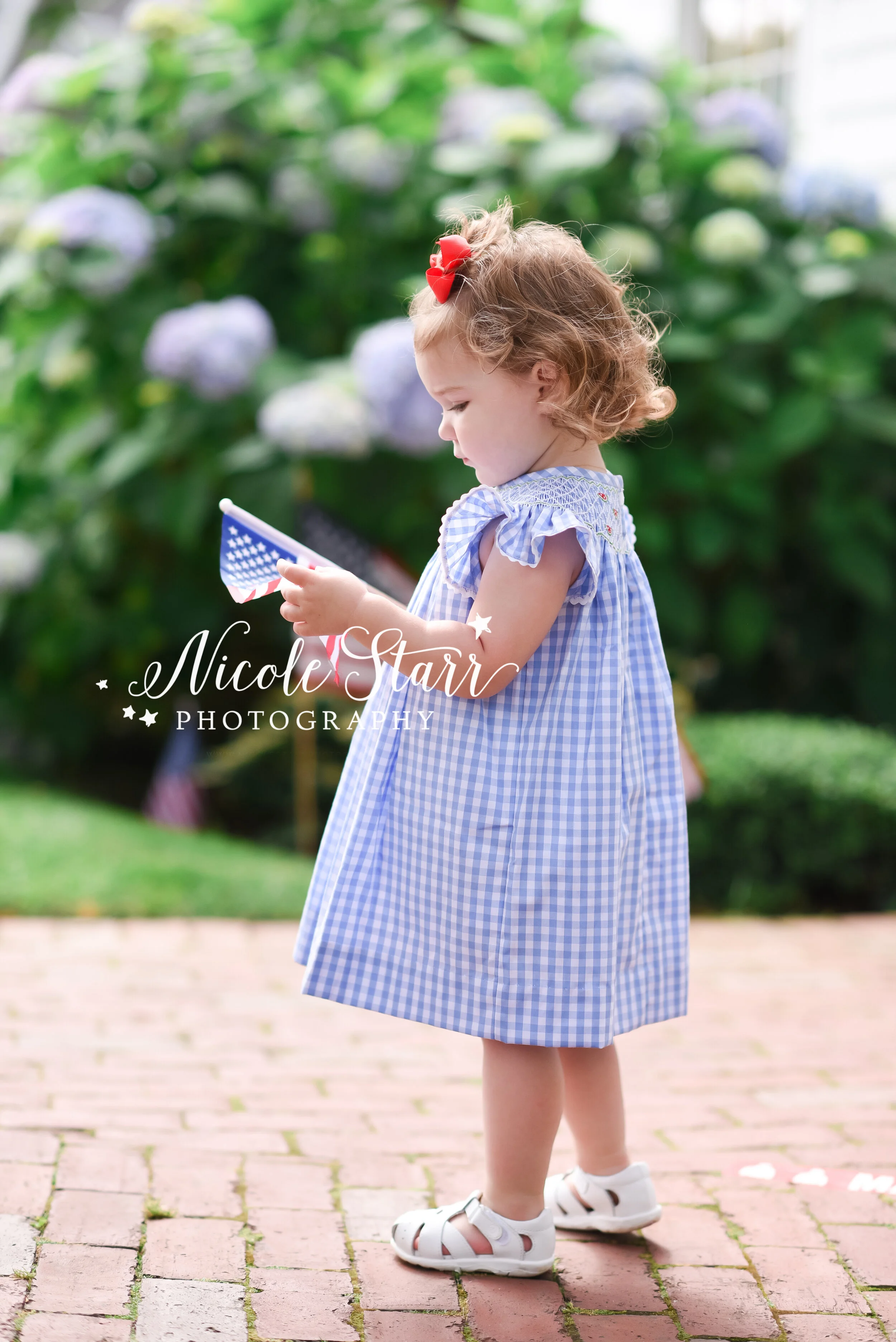 Little girl waves American flag photographed by Cape Cod family and beach photographer Nicole Starr Photography | Classic Cape Cod portraits