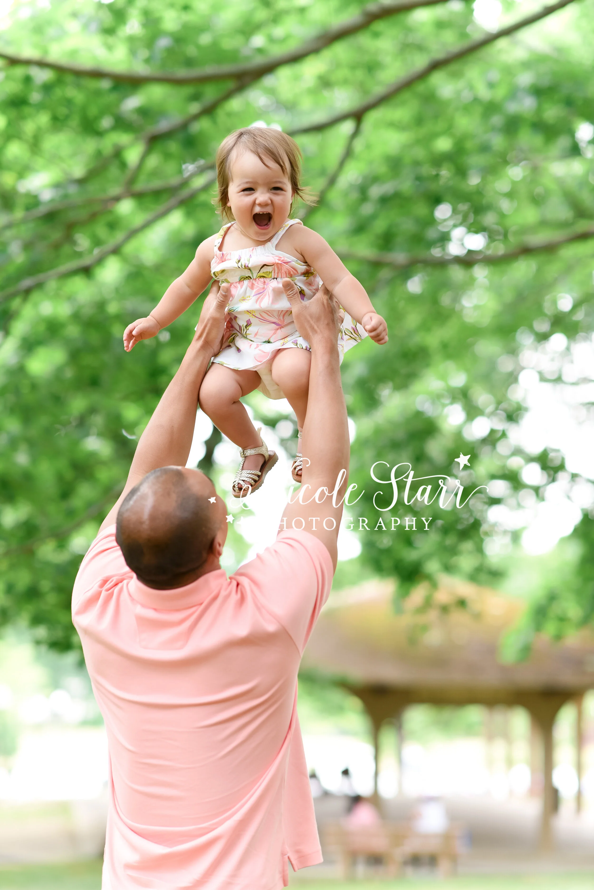 dad lifts baby girl in the air photographed by New York family photographer Nicole Starr Photography | Albany NY family photographer, Boston family photographer, Delmar NY family photographer